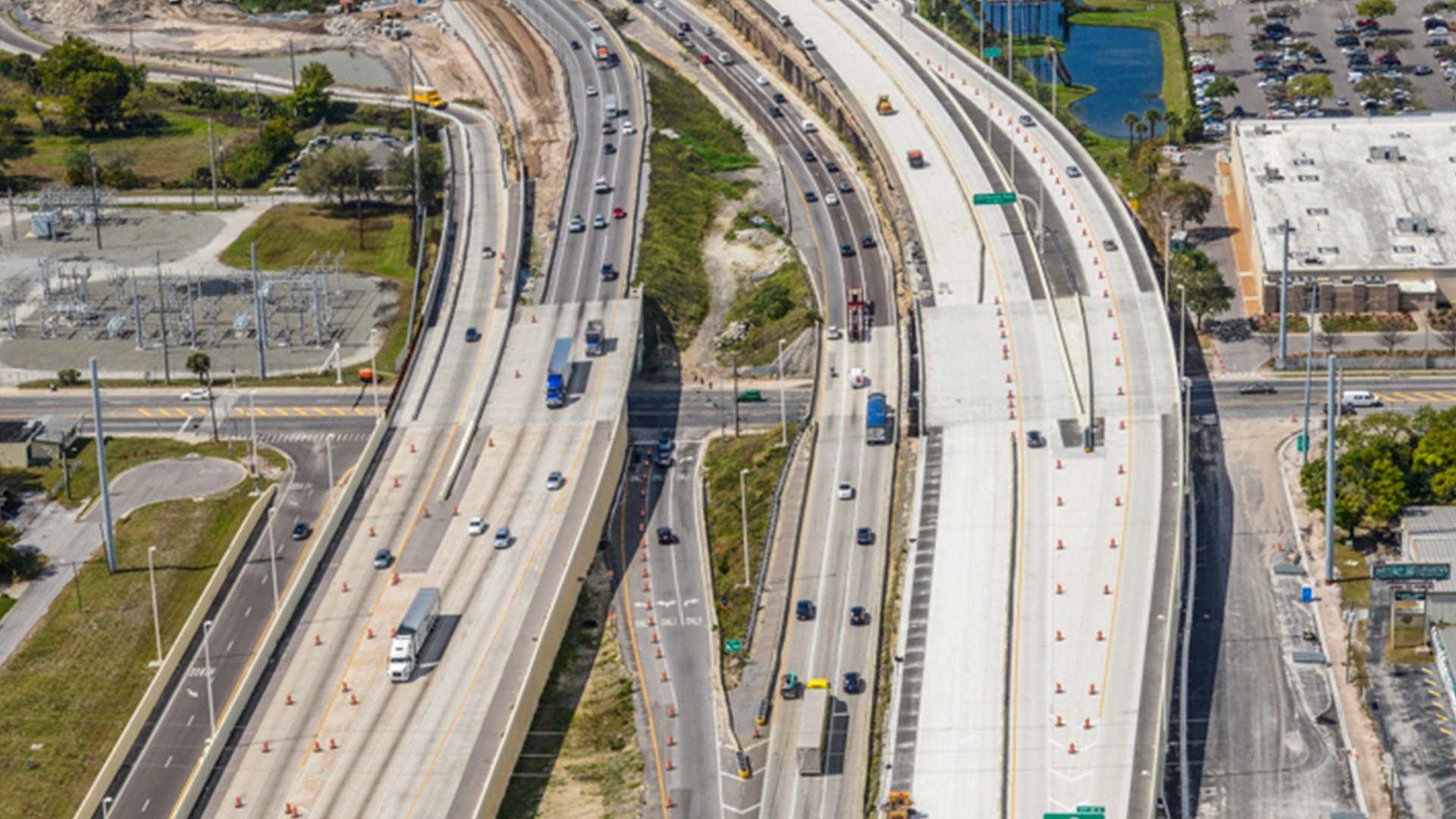 Aerial View of Highway Construction and Traffic Flow Aerial view of busy multilane highway with trucks and cars in urban area.