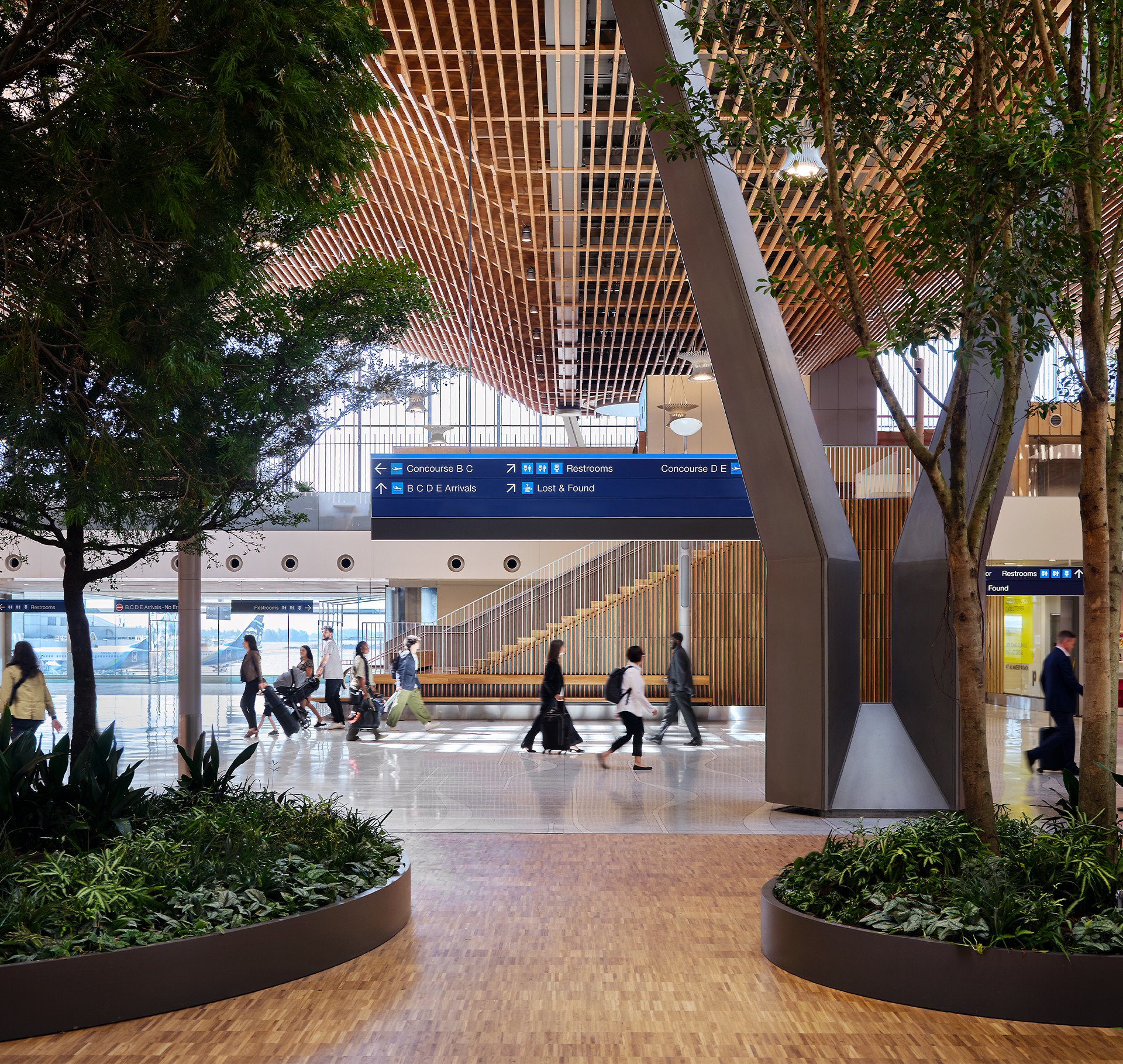 Modern airport terminal interior with travelers walking and natural wood ceiling design.