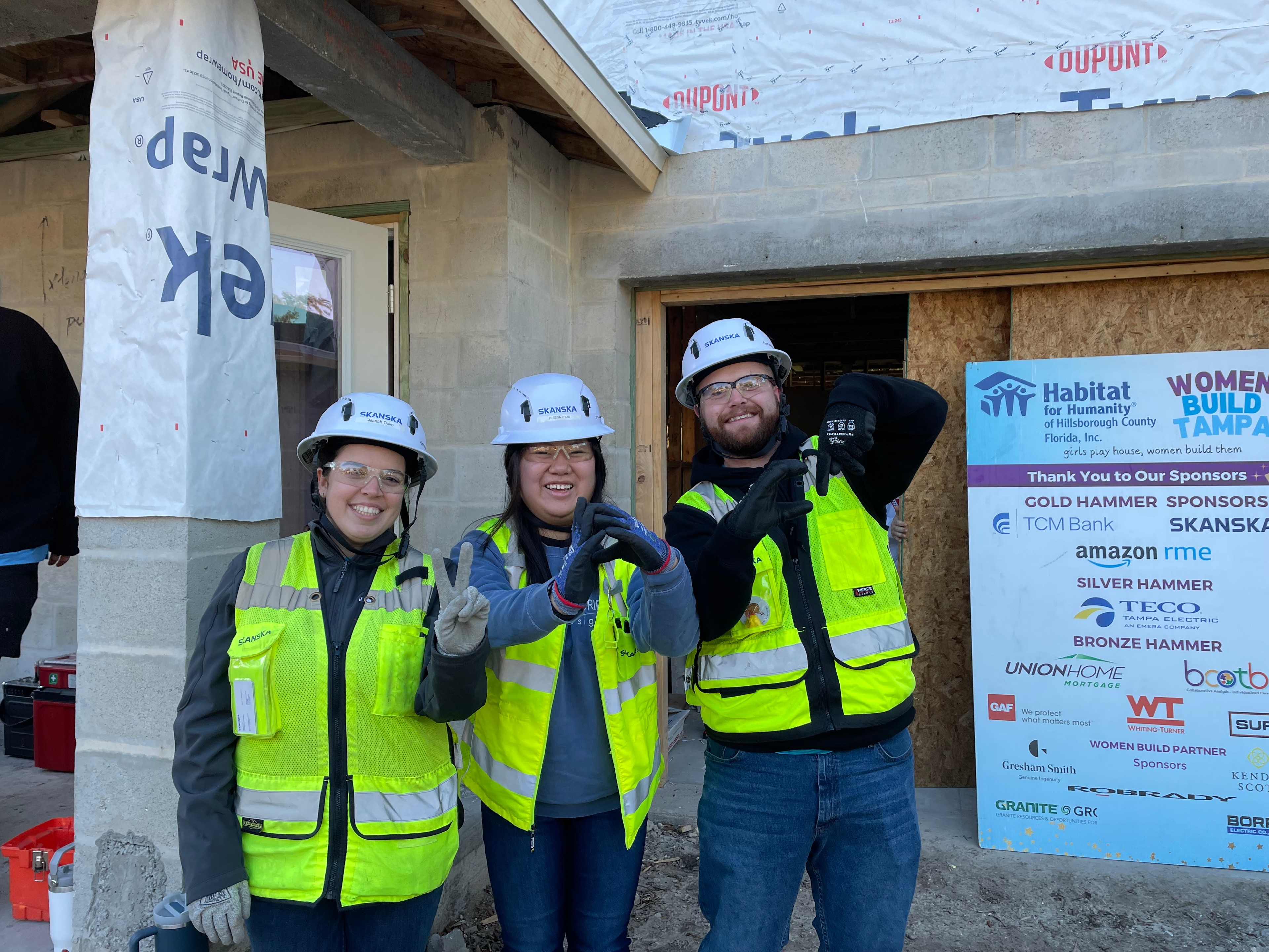 Volunteers in Safety Gear at Habitat for Humanity Build Site Skanska team volunteering at construction site.