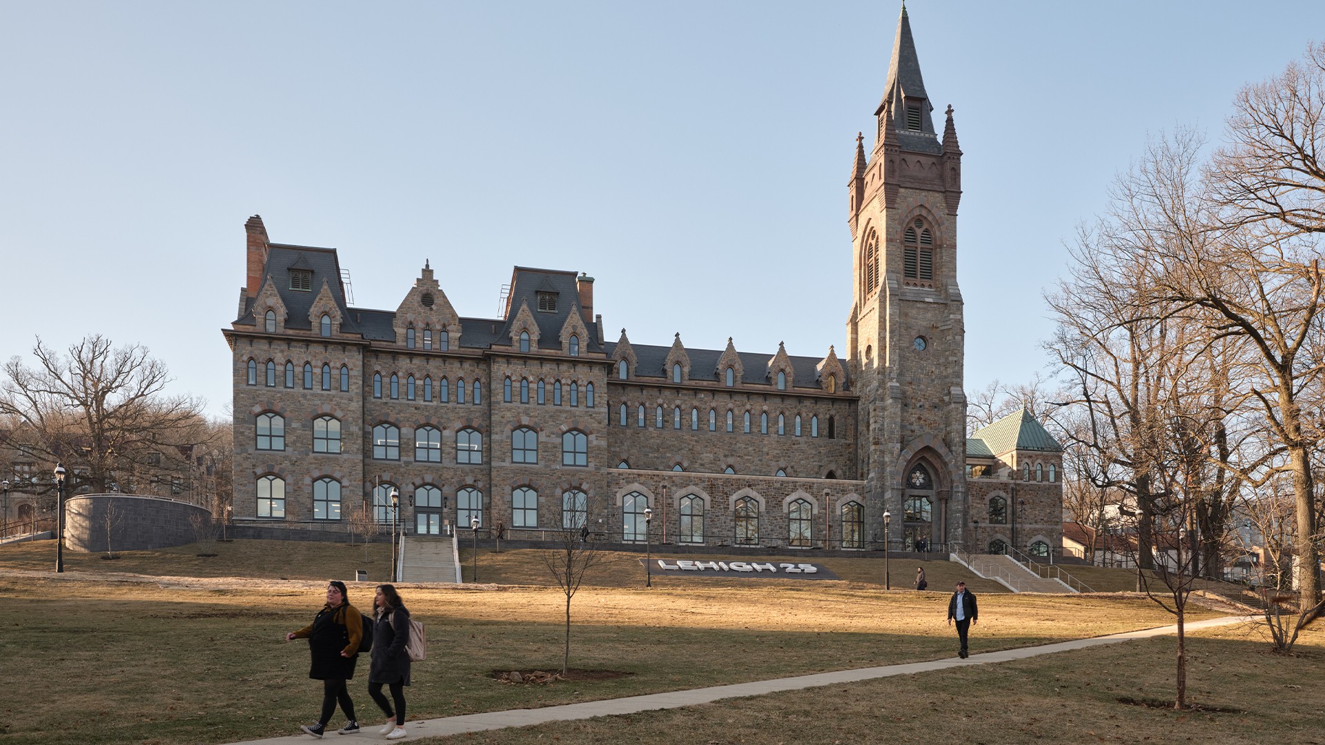 Education lab with Orange Chairs and Advanced Equipment Exterior shot of an academic building with students walking on pathways