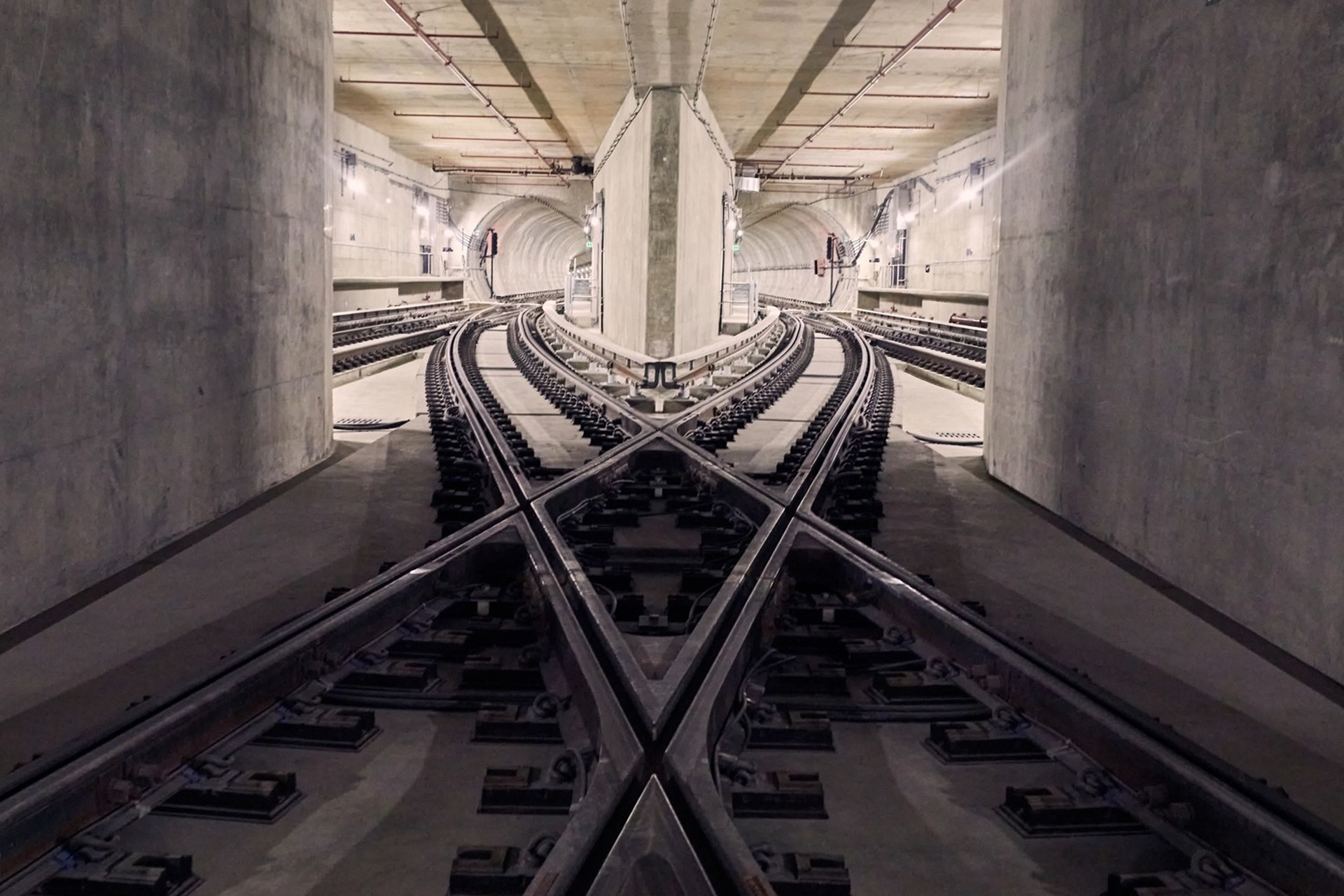 Underground Metro Rail Tracks with Switch Points in Tunnel Underground railway tracks with a complex switch system in a concrete tunnel.