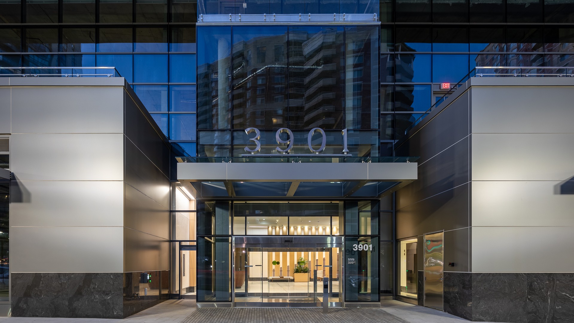 Modern Office Building Entrance at 3901 with Glass Facade Modern glass building entrance with the address number 3901 prominently displayed.