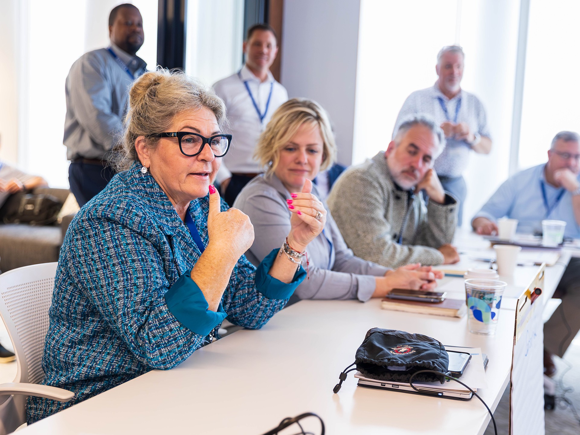 A group of professionals engaged in a meeting around a conference table in office.