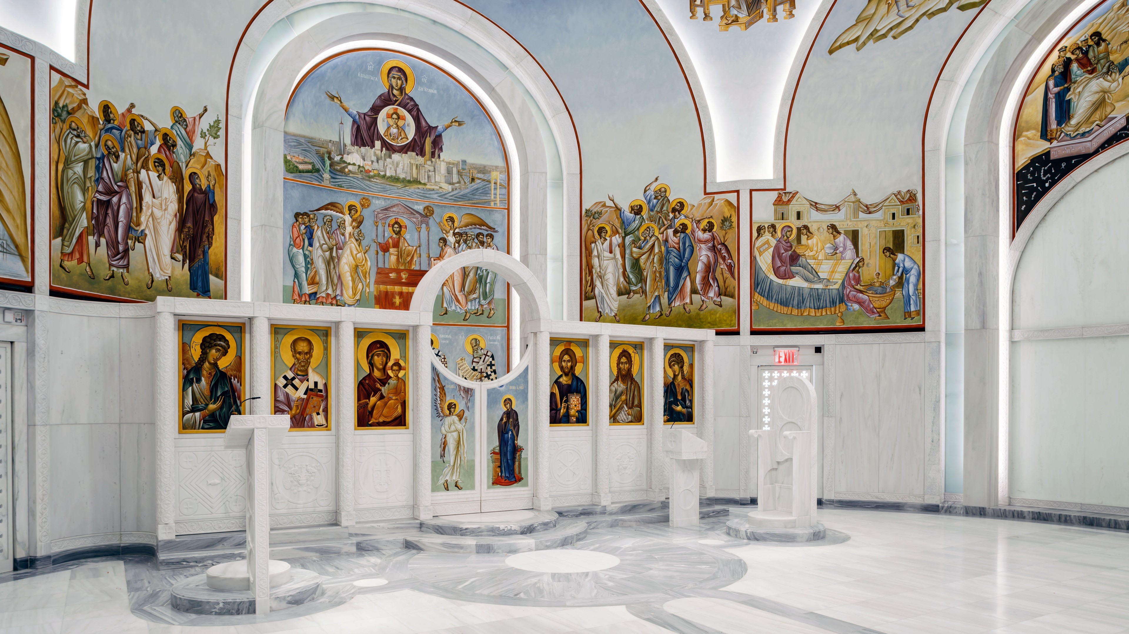 Concert Hall with Elegant Lighting and Seating Interior of a bright Orthodox church with religious icons and marble flooring.