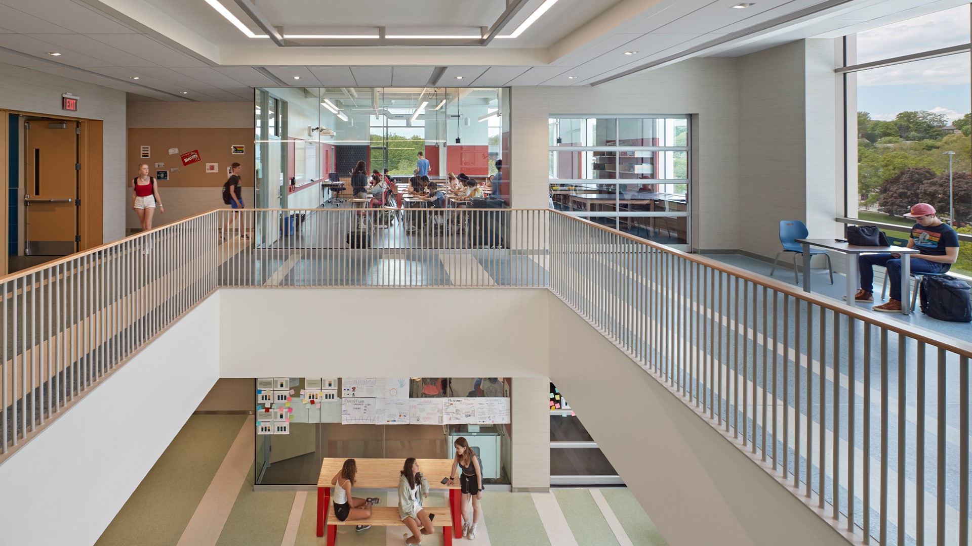 School Library Interior with Wooden Ceiling and Bookshelves Modern school interior with students studying and socializing in bright open spaces.