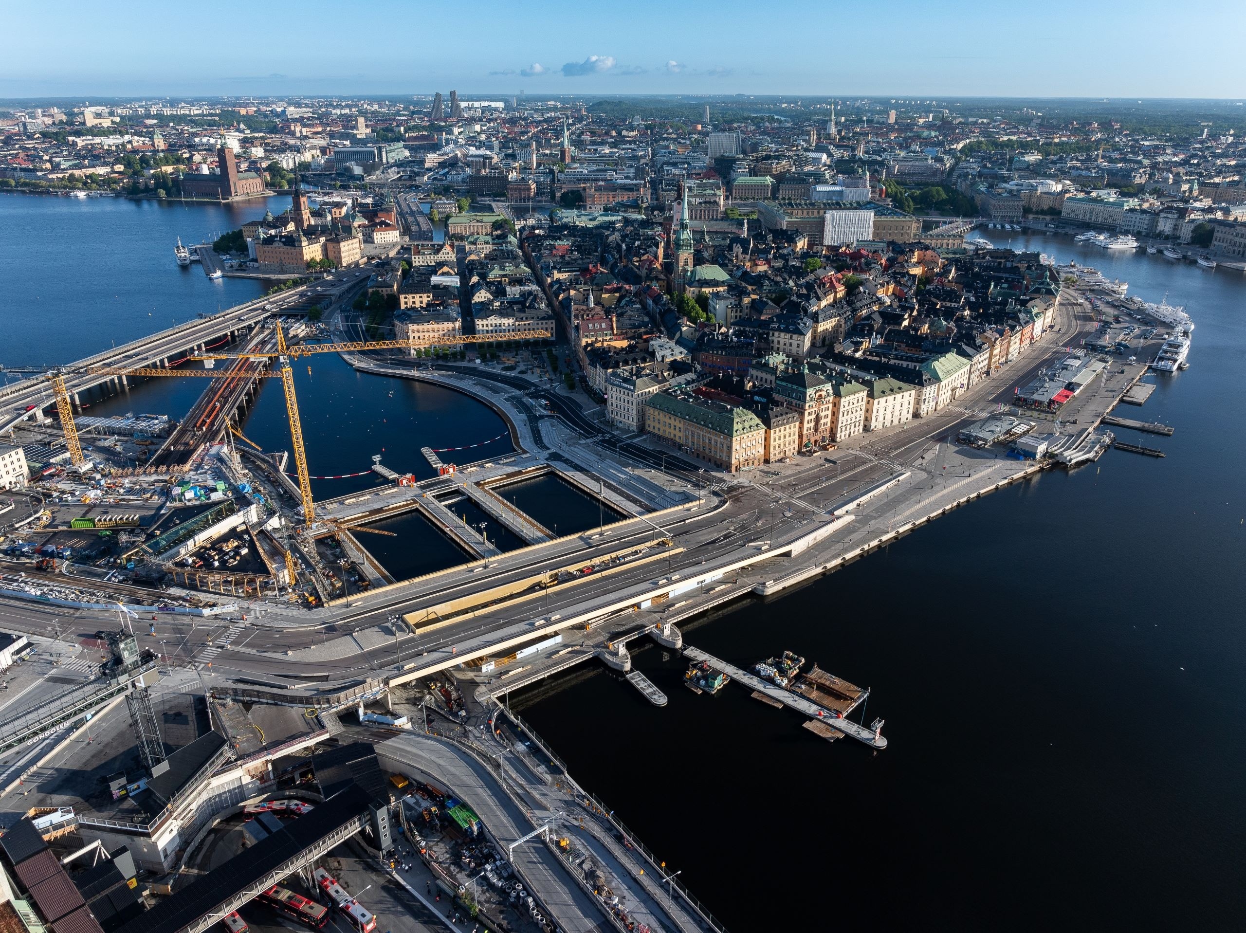 Aerial view of Stockholm, showcasing construction near waterfront and historic cityscape.