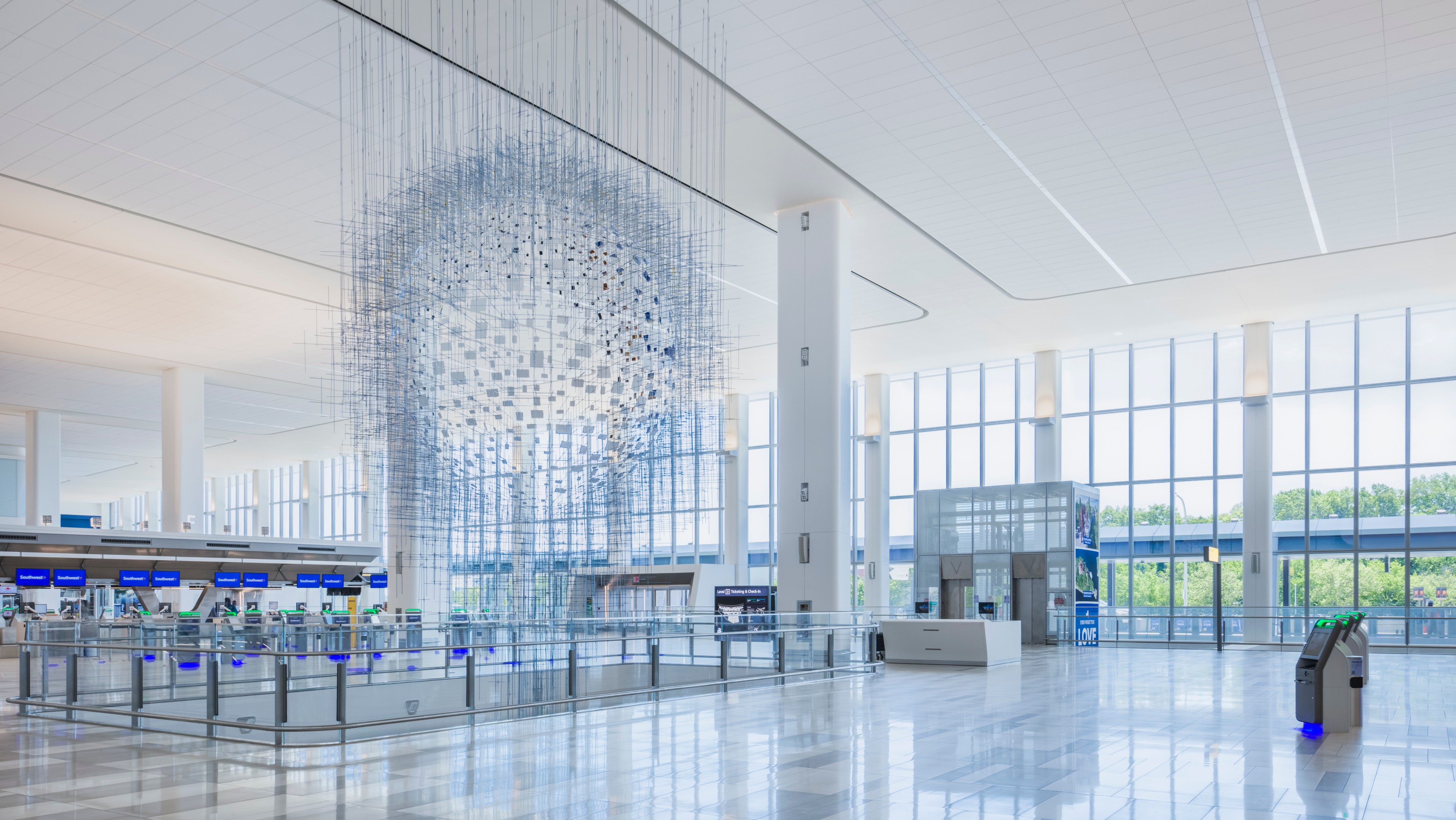 LGA Terminal with Stunning Hanging Sculpture LGA terminal with a large, intricate hanging sculpture and expansive windows.