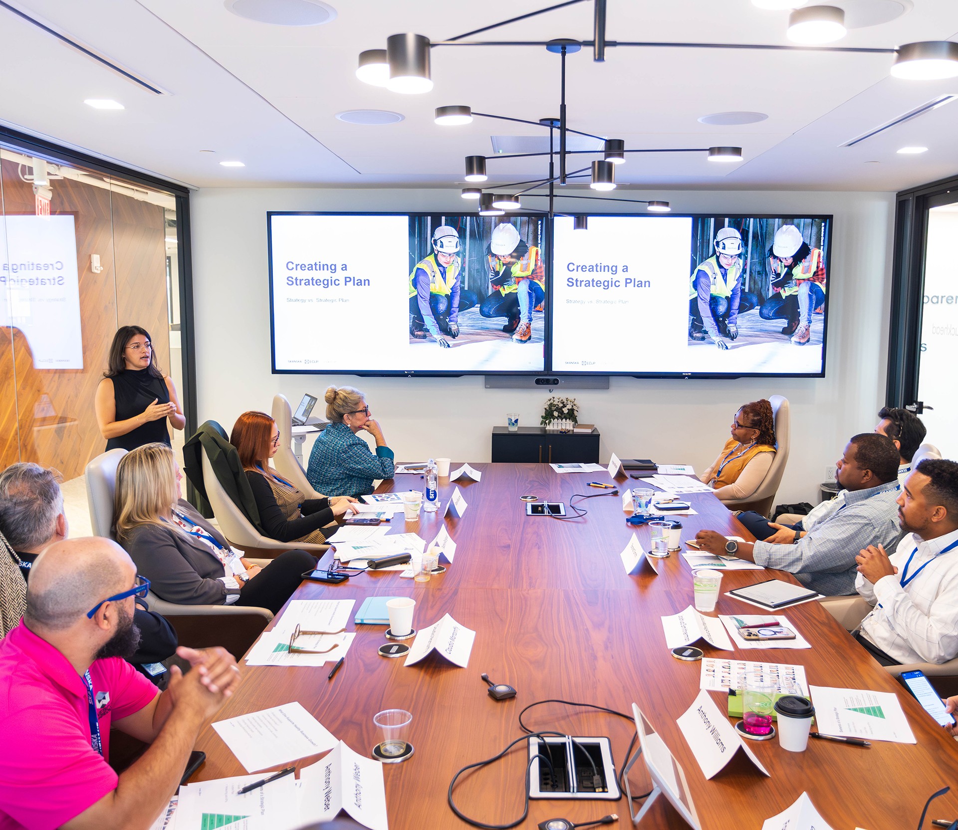 Team Strategic Planning Meeting in Modern Conference Room A diverse business team attending a strategic planning meeting in a modern conference room.