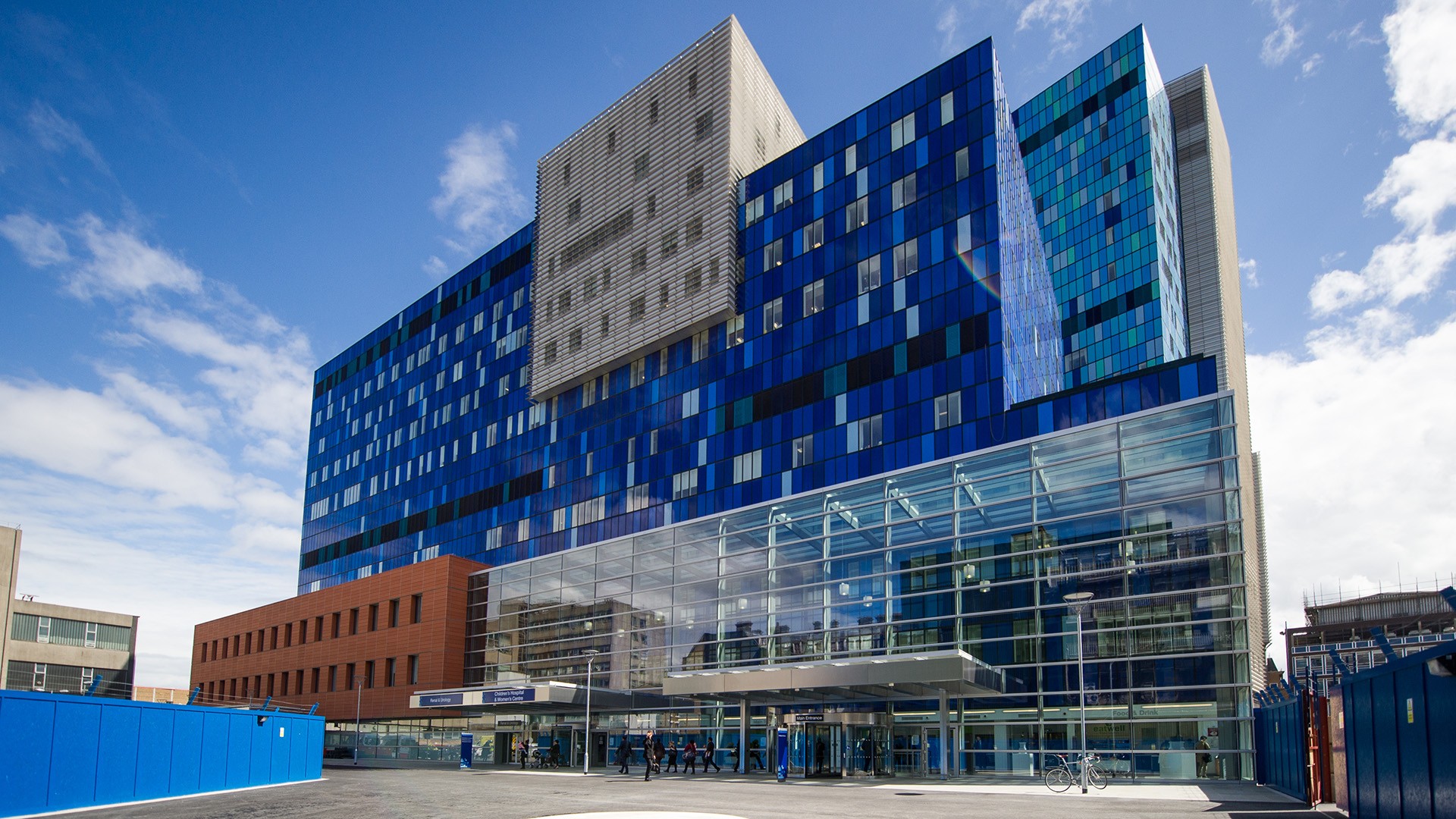 Royal London Hospital in east London Modern hospital building with vibrant blue glass facade and spacious entrance under a clear sky.