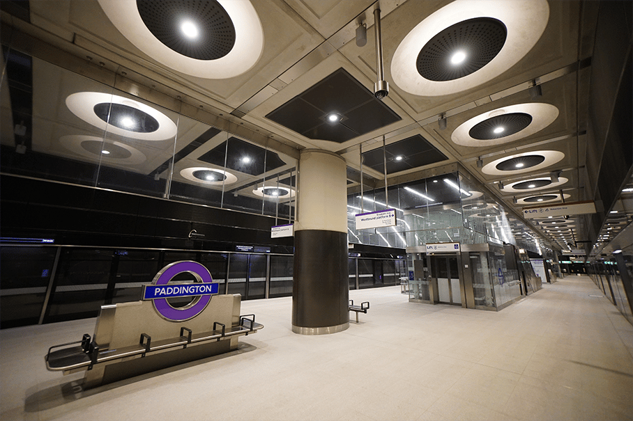Modern Paddington Underground station platform with sleek design, signage, and seating areas.
