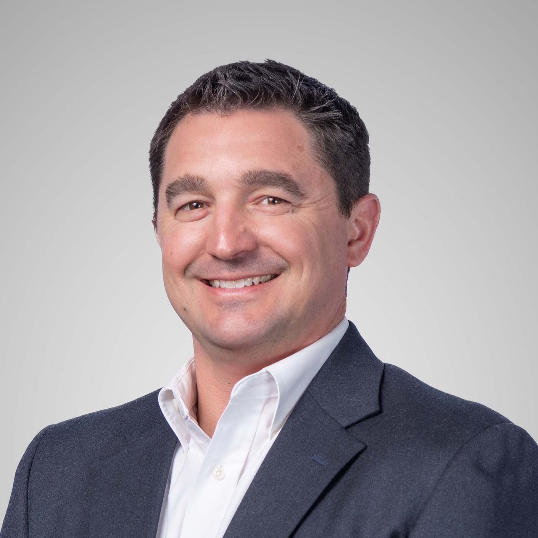 Professional Business Attire on Grey Background A man in a suit and white shirt against a gray background, representing professional attire.