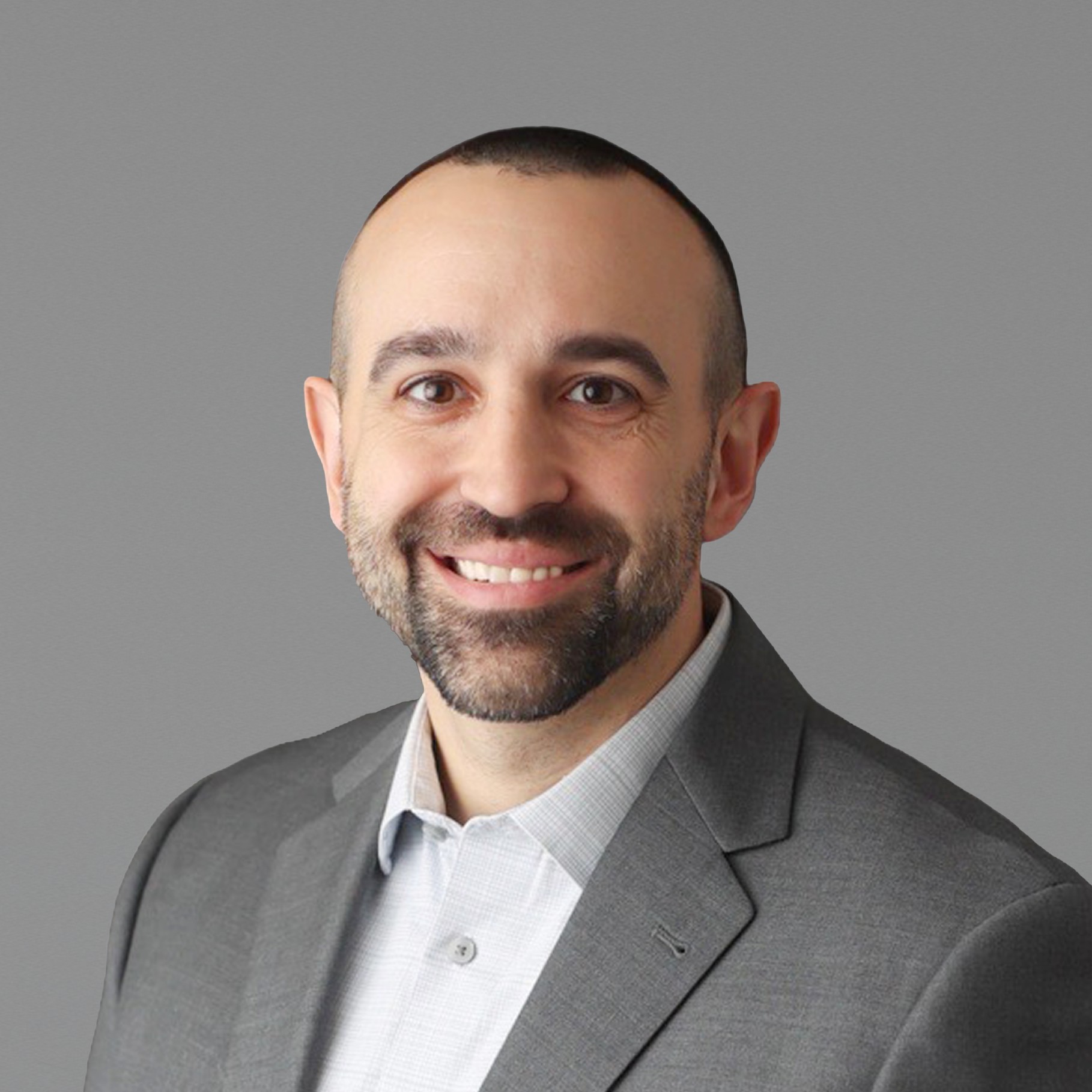 Professional man in gray suit with white shirt on gray background Anthony in gray suit jacket and white shirt against a plain gray background.