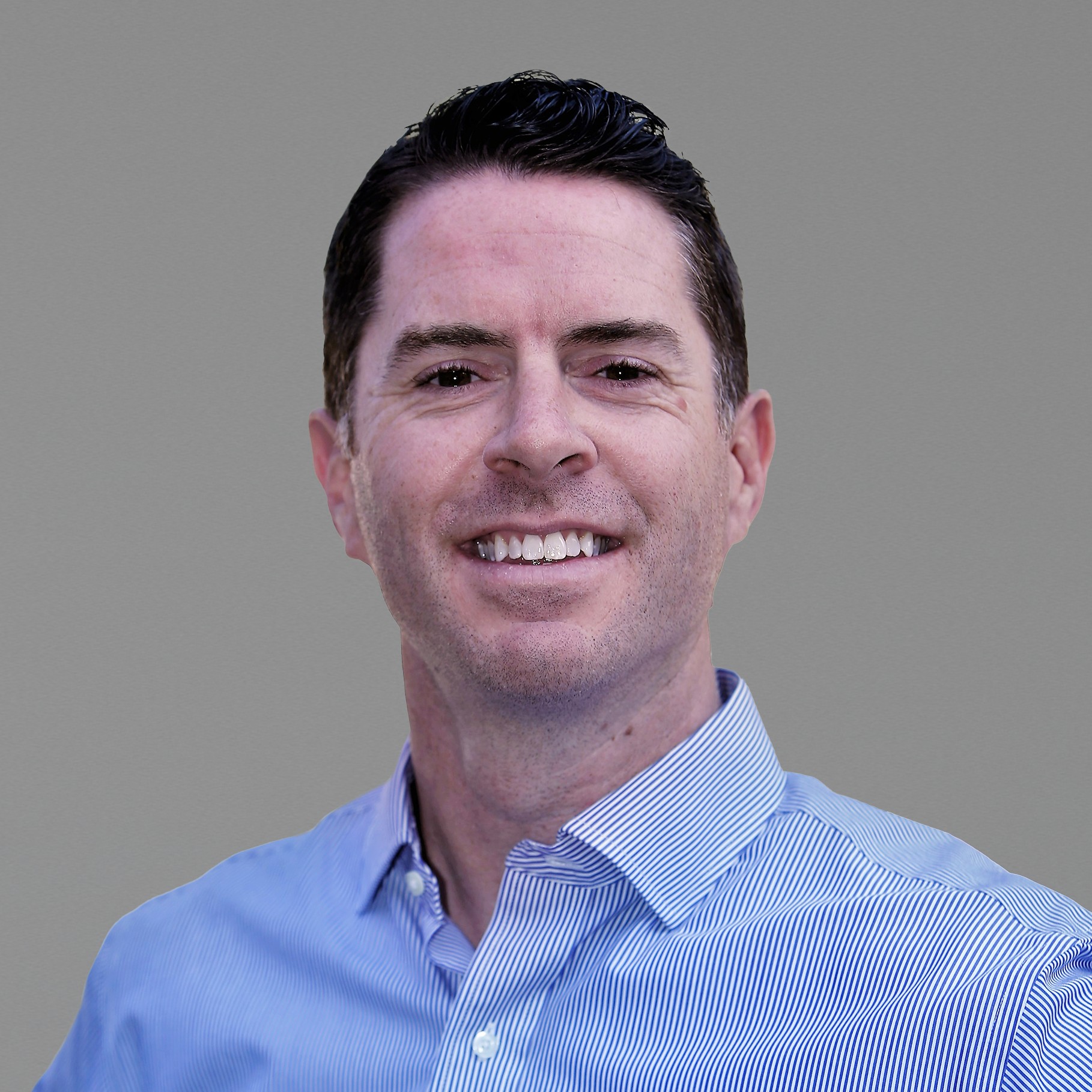 Professional man in blue striped shirt with neutral background Michaelwearing a blue striped dress shirt against a gray background.