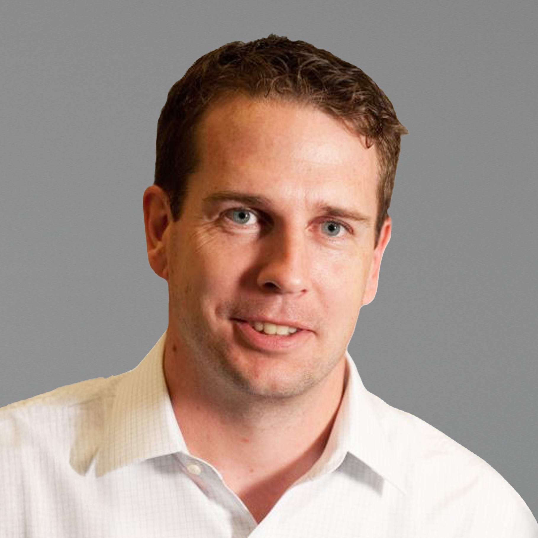 Professional man in white shirt against gray background portrait Philip wearing a white dress shirt against a plain gray background.