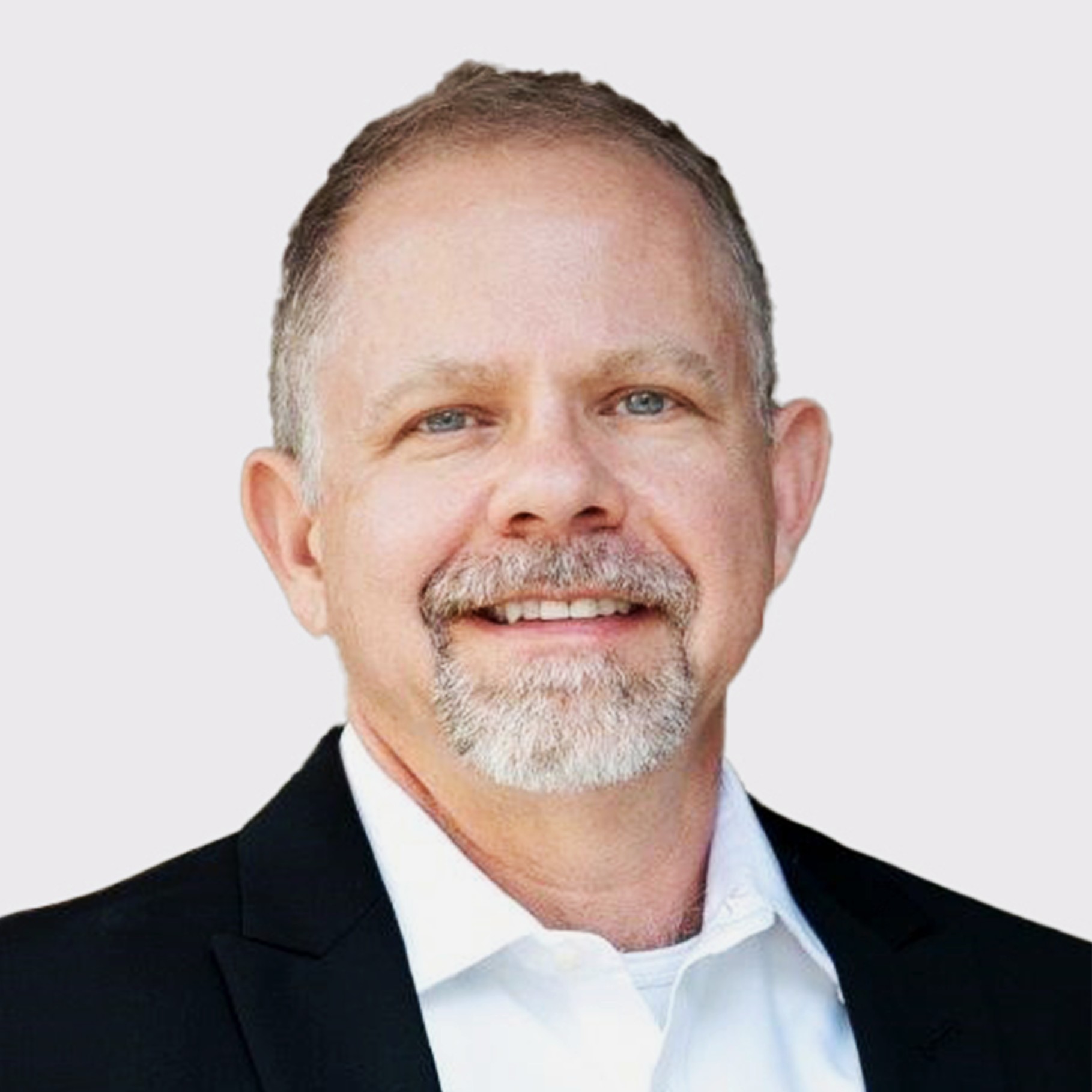 Professional businessman in suit with white shirt on neutral background Professional man in a black suit jacket and white shirt against a light background.