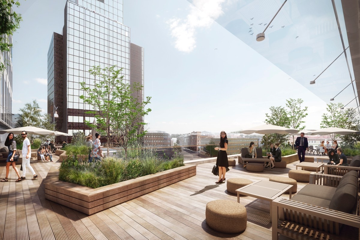 Modern rooftop terrace with seating, planters, and people enjoying a sunny urban environment.