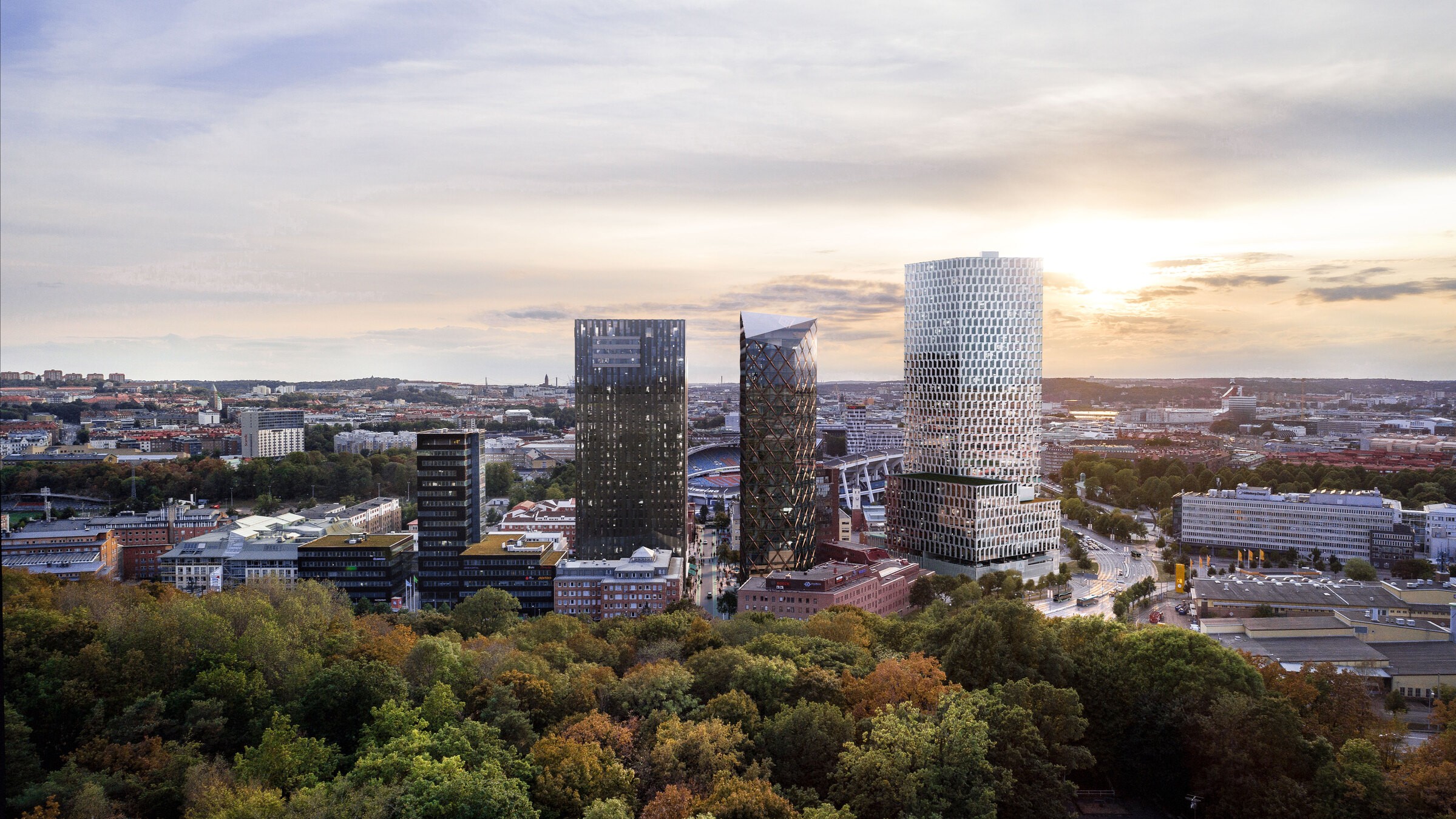 Aerial view of a modern cityscape featuring tall skyscrapers and lush greenery at sunset.