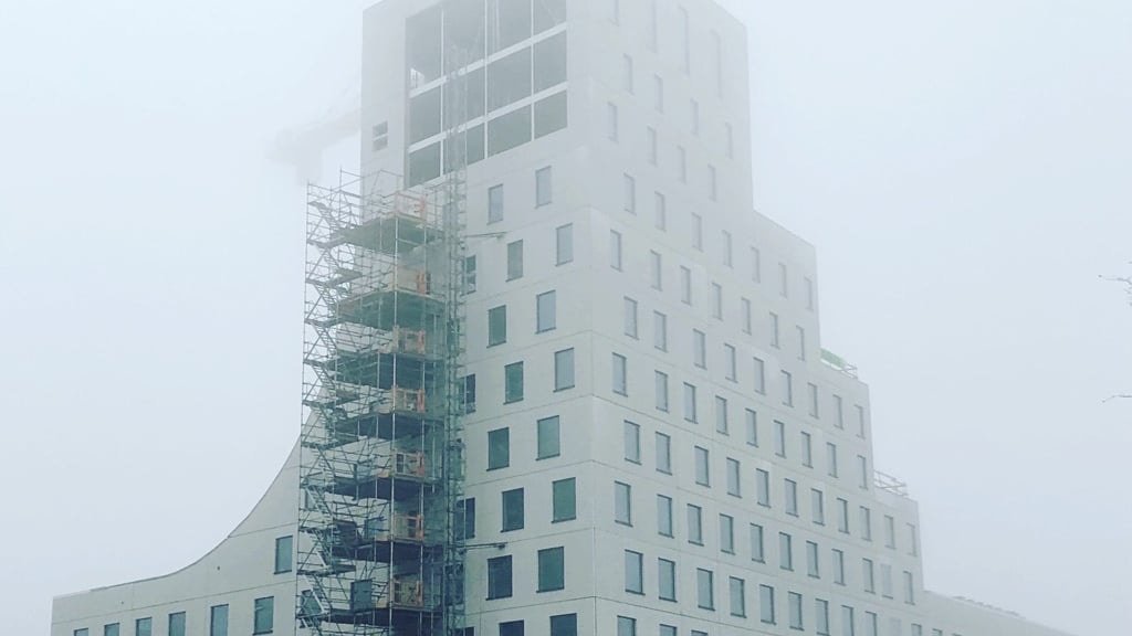 The hotel with scaffolding during the construction phase.