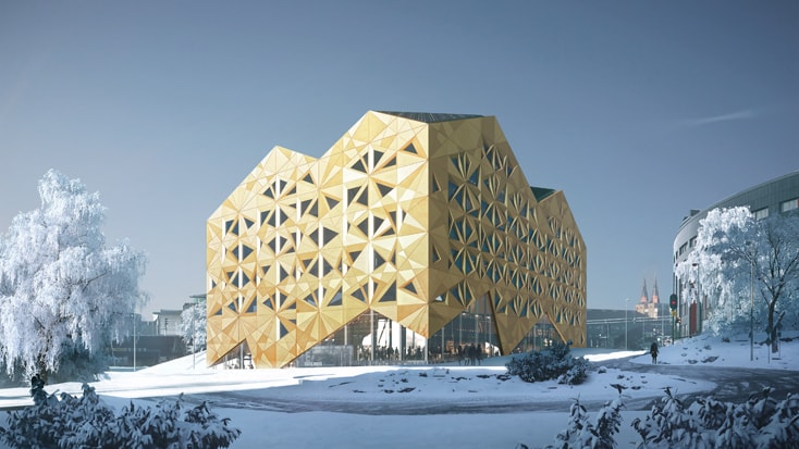 Modern geometric building with gold facade surrounded by snow-covered landscape.