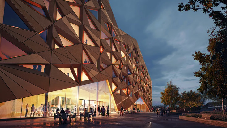 Geometric building facade with triangular patterns, glass entrance, and people dining outdoors.