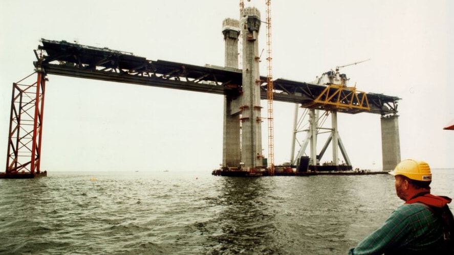 The Öresund Bridge Construction of a large bridge over water with cranes and support structures visible.