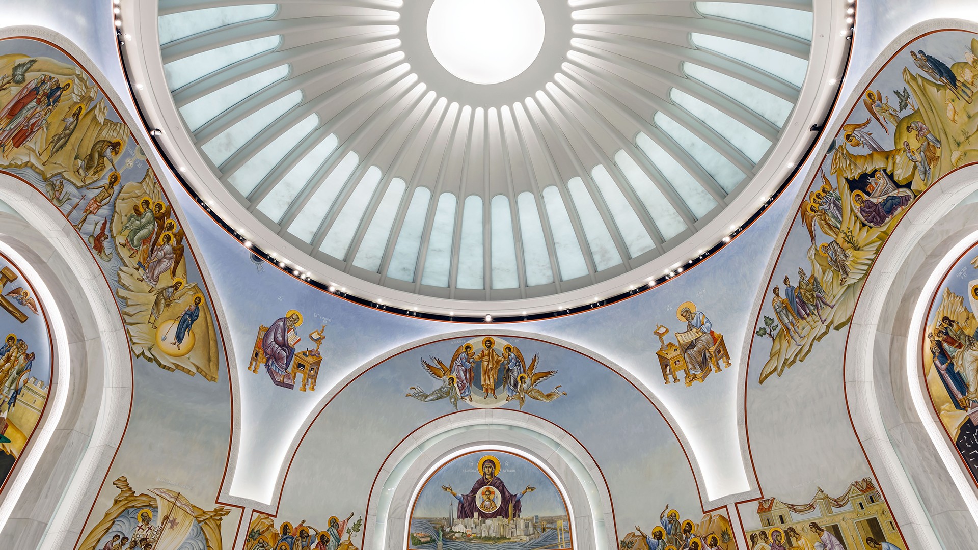 Interior dome of a church with religious frescoes and a circular skylight.