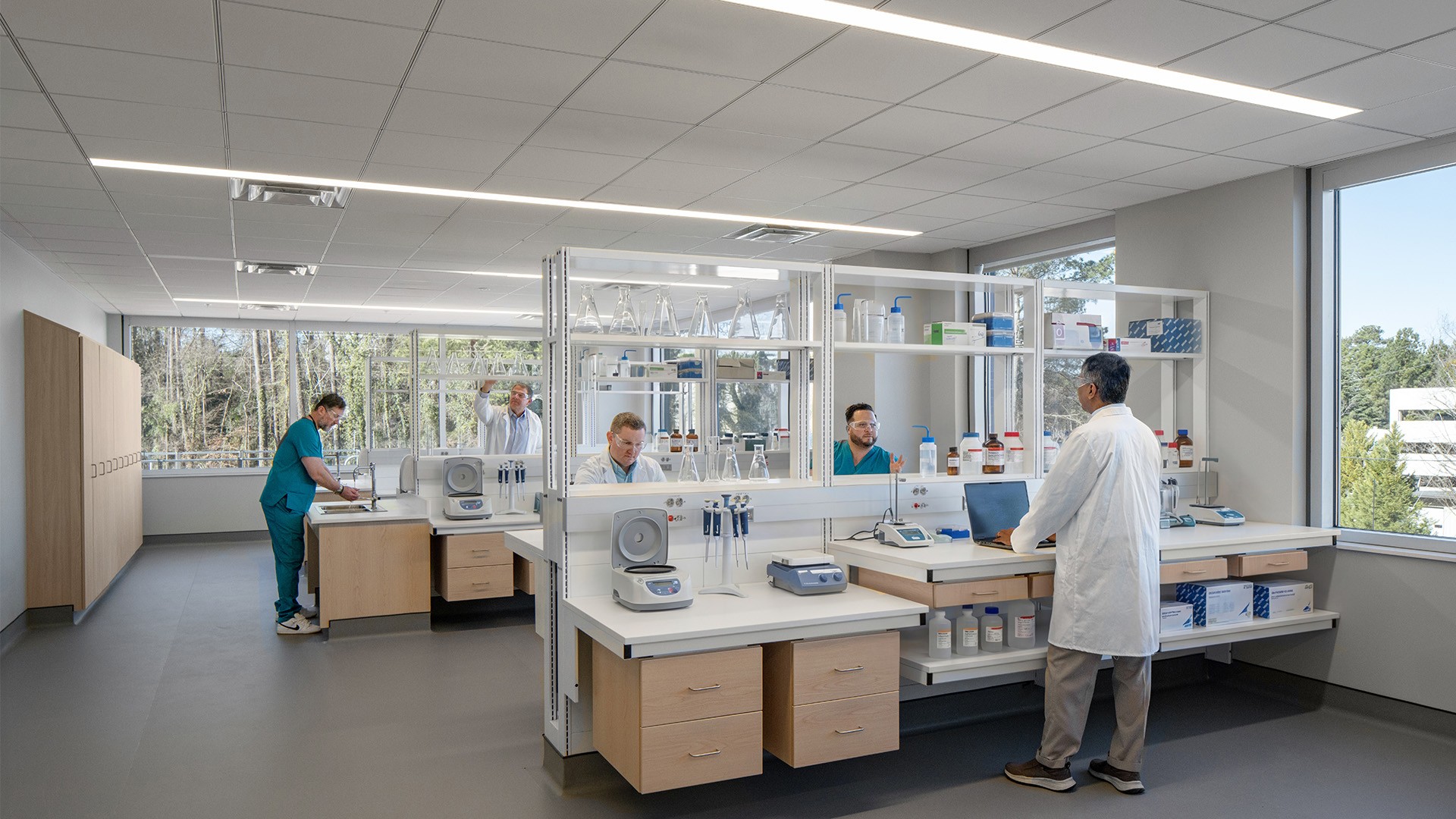 Modern laboratory with scientists working on experiments and advanced equipment.