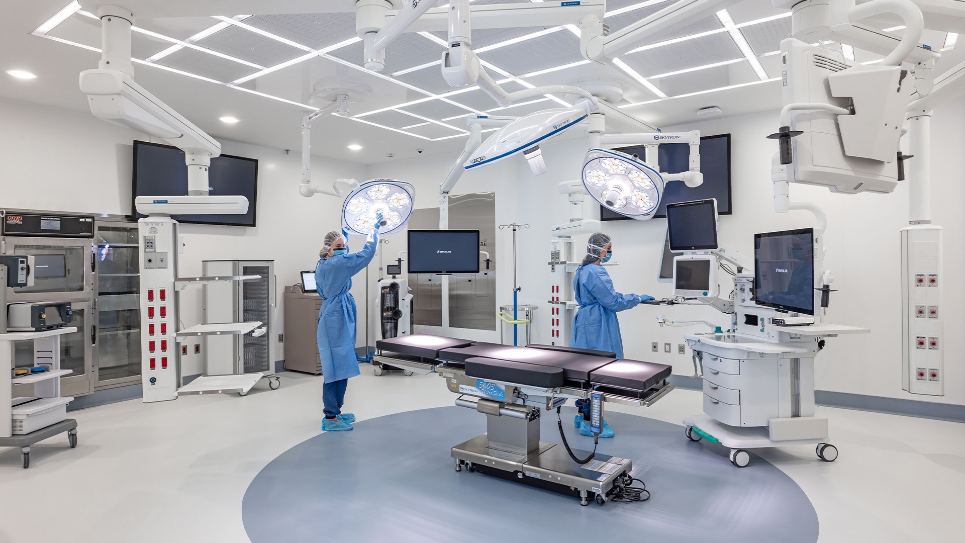 Advanced surgical operating room with bright lights and surgeons prepping. Advanced surgical operating room with bright lights and surgeons prepping.