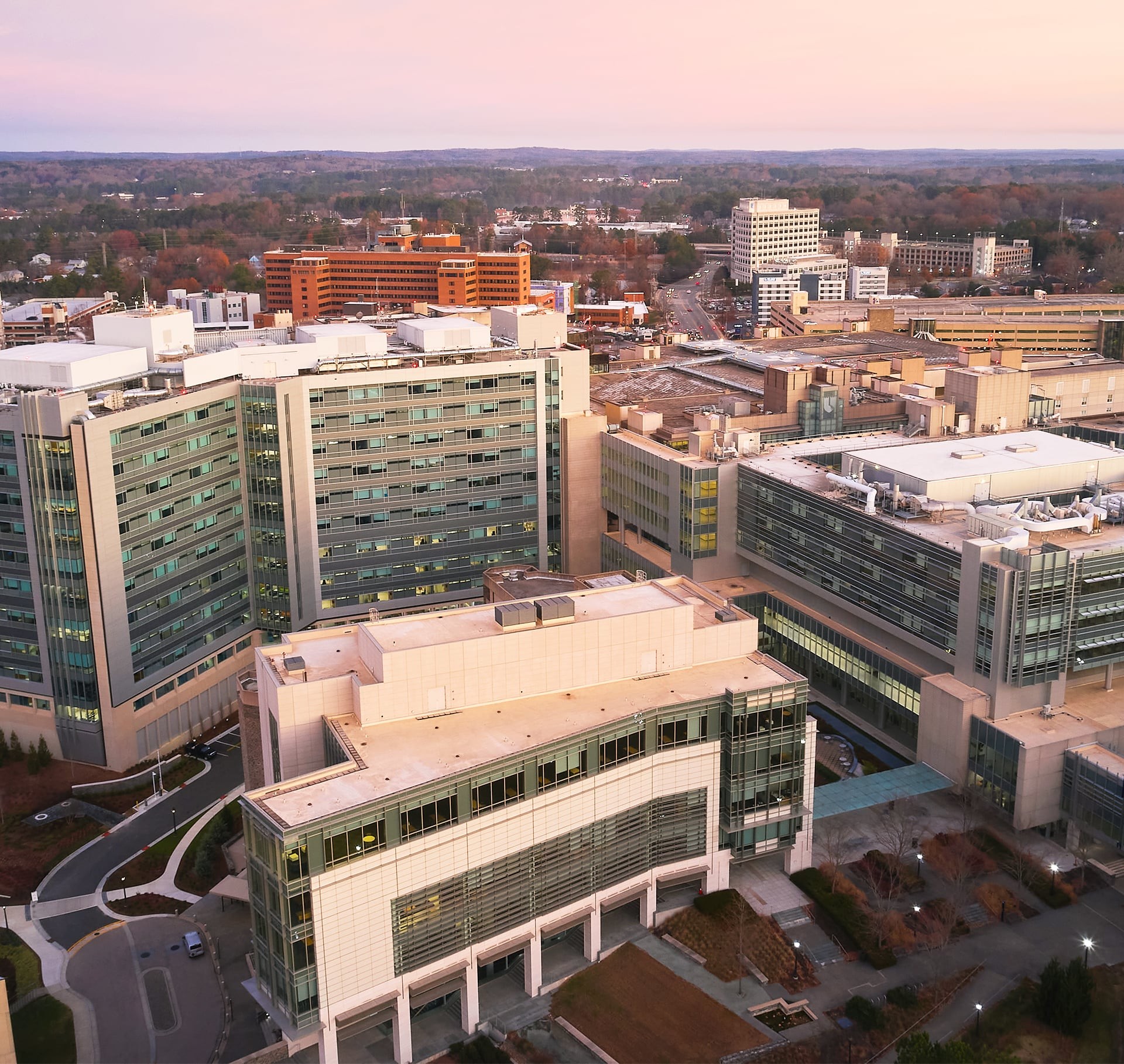 Aerial view of a modern hospital complex with multiple large buildings and surrounding roads.