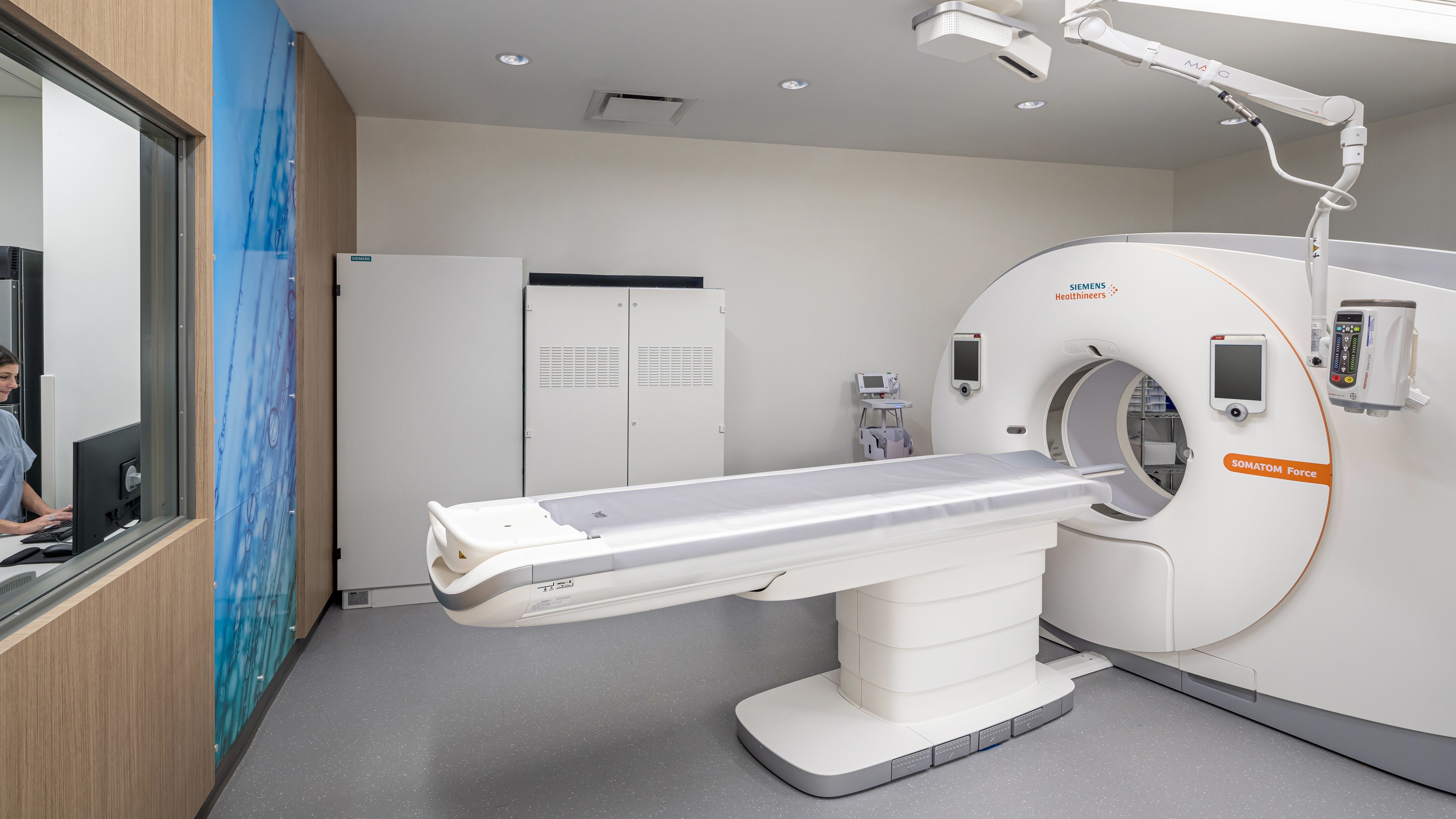 Advanced CT Scanner Machine in Modern Medical Imaging Room Modern CT scanner machine in a clean, well-lit medical imaging room for diagnostic use.