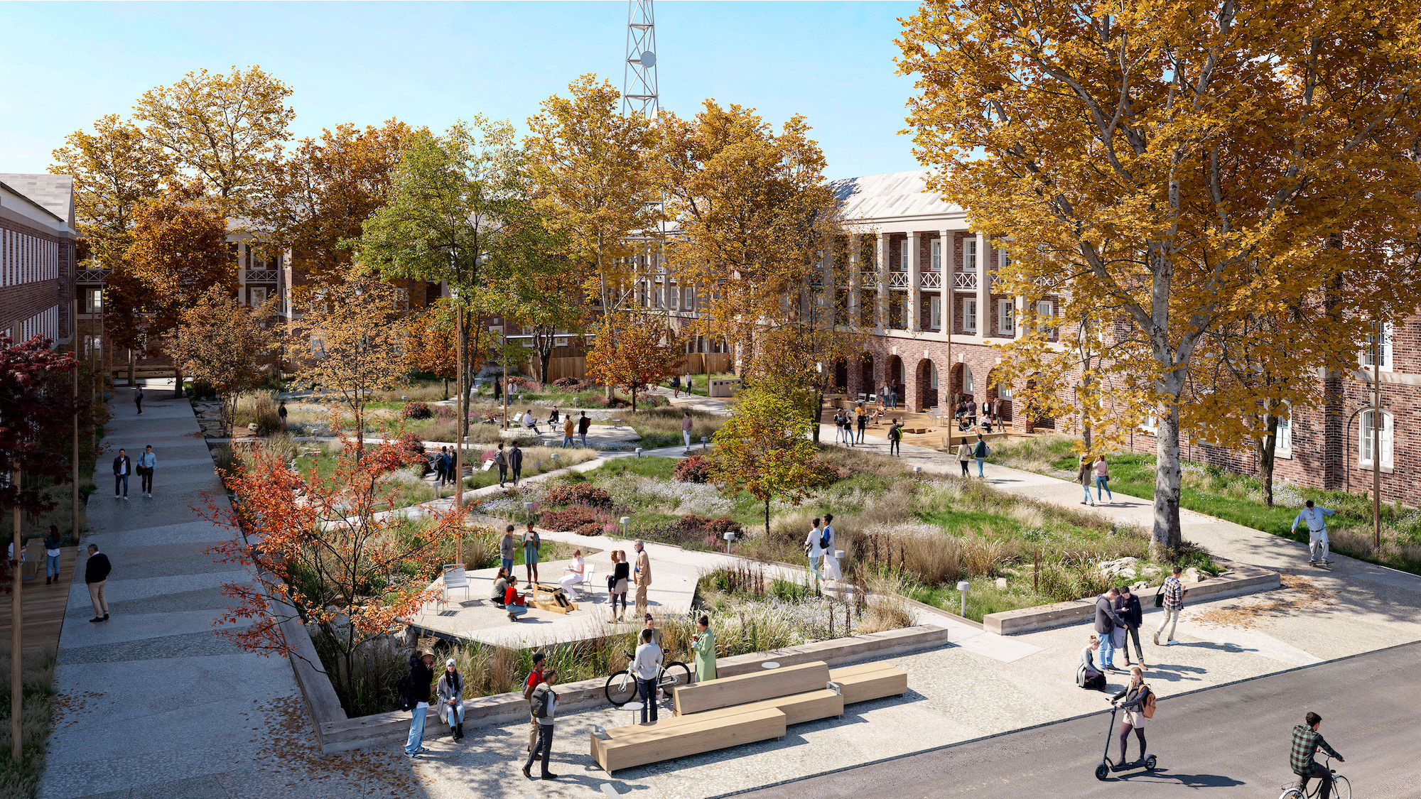 Autumn campus courtyard with students walking, sitting, and socializing outdoors.