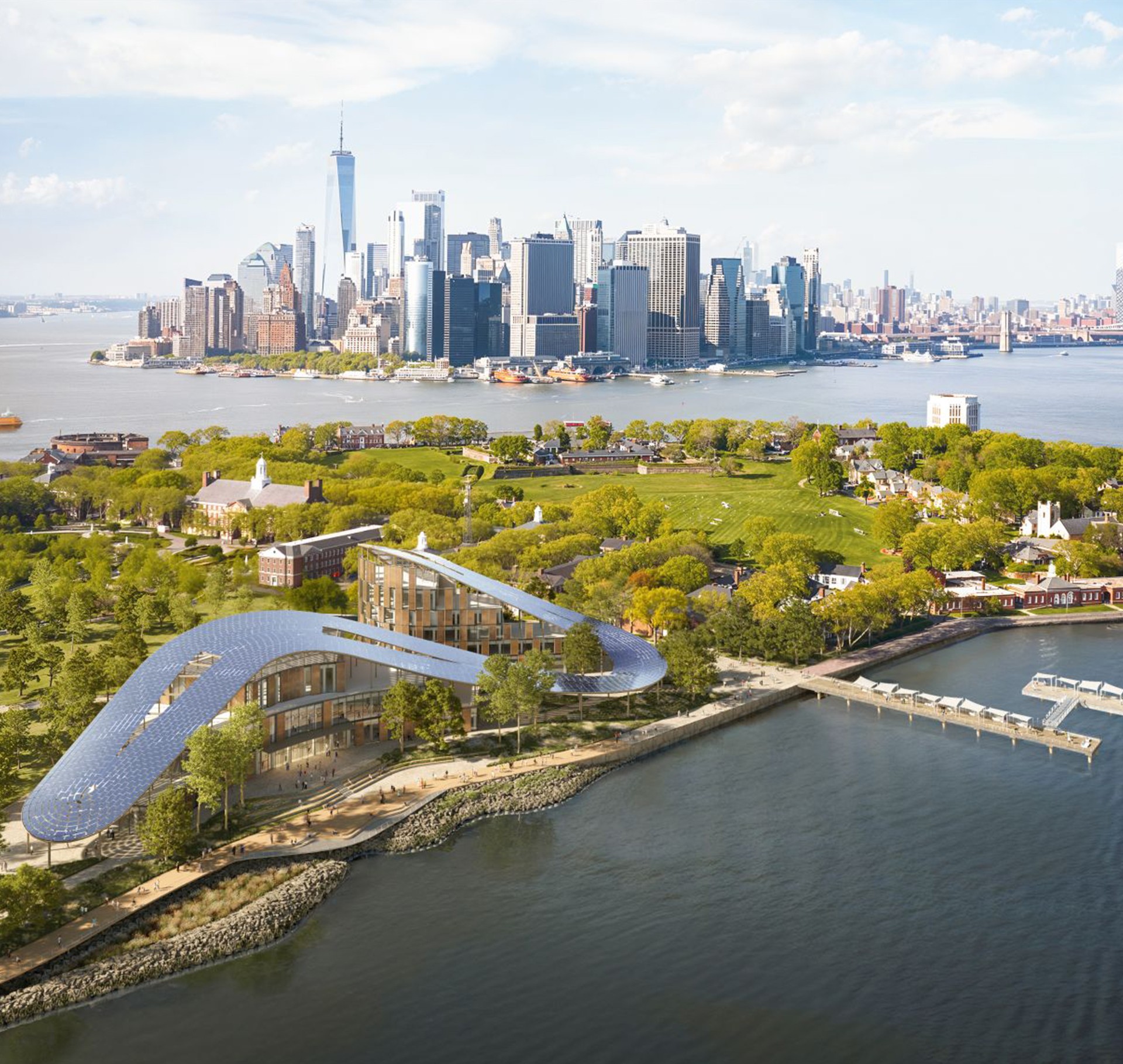 Modern waterfront architecture with NYC skyline in background Aerial view of Governors Island with modern buildings and Manhattan skyline in background.