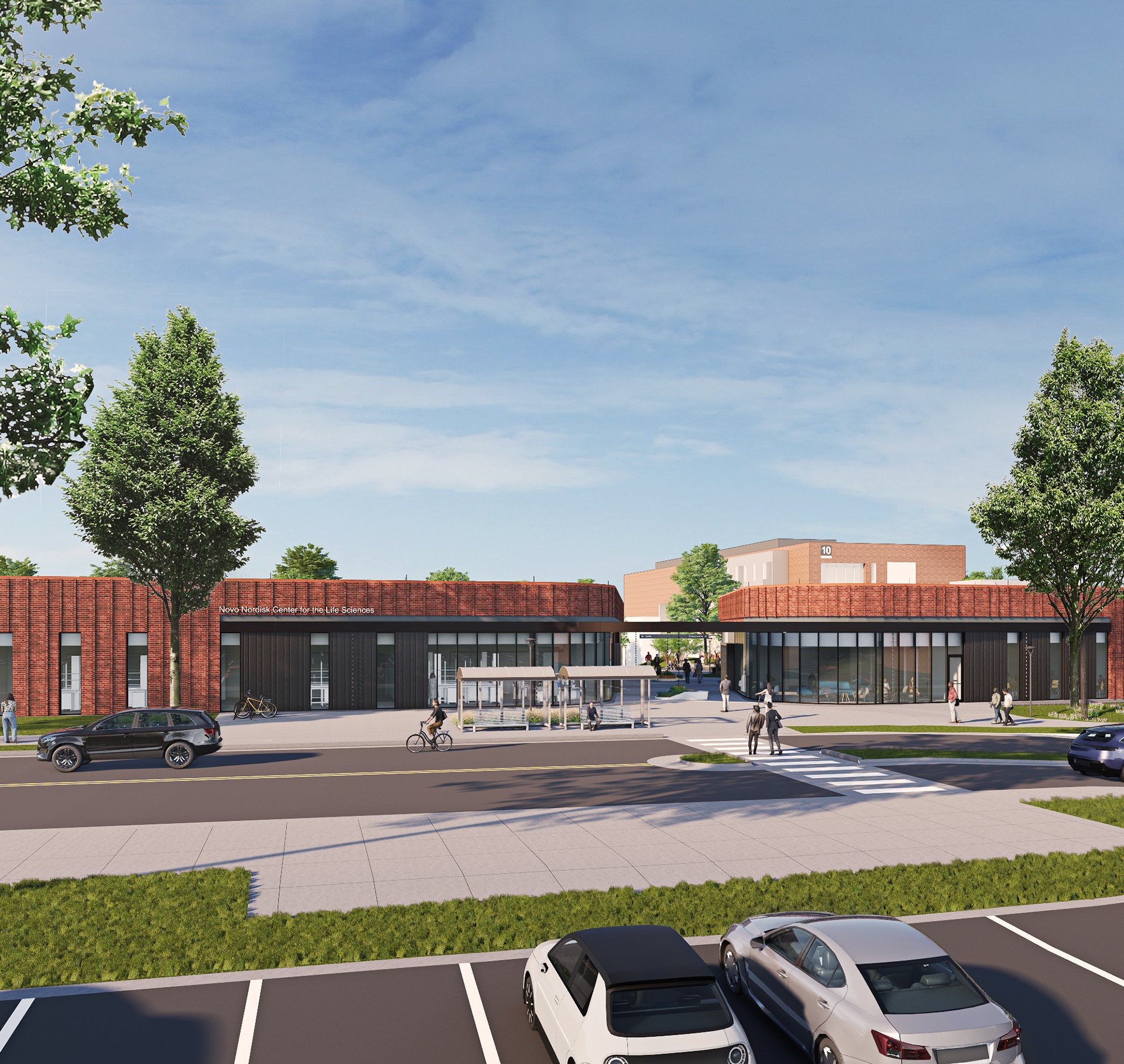 Modern Life Sciences Center with Outdoor Bicycle and Parking Area Modern educational center with brick facade, large windows, trees, and parked cars.