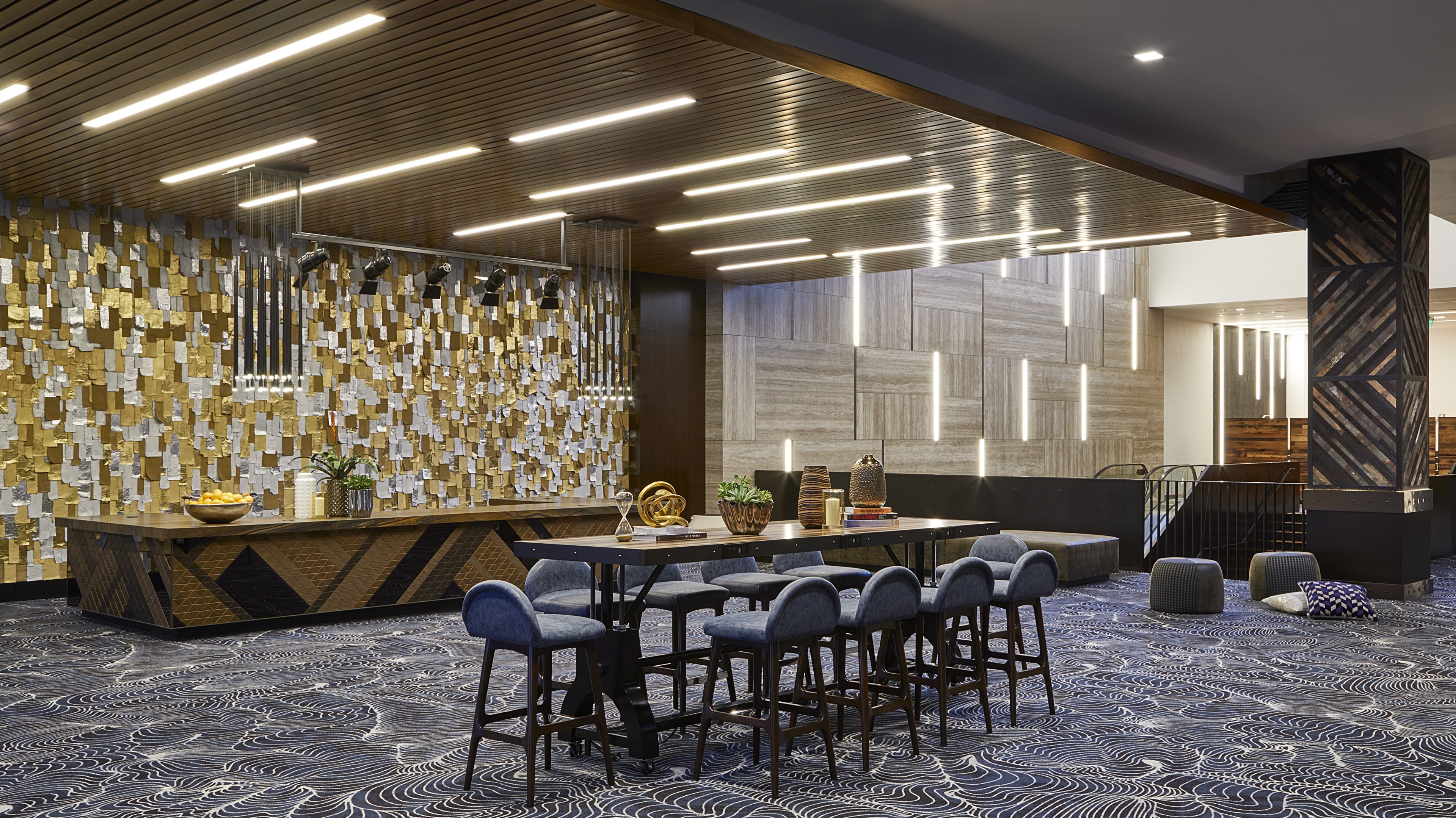 Modern conference room with stylish chairs, patterned carpet, and decorative lighting.
