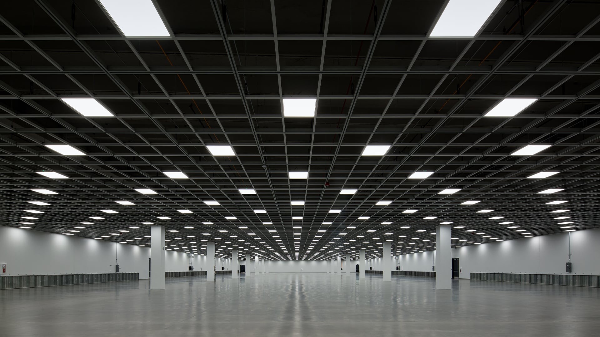 16x9 Aspect Ratio: 1920x1080 Resolution Template Design Spacious, modern, grid-ceiling interior with polished floors and evenly spaced square lights.