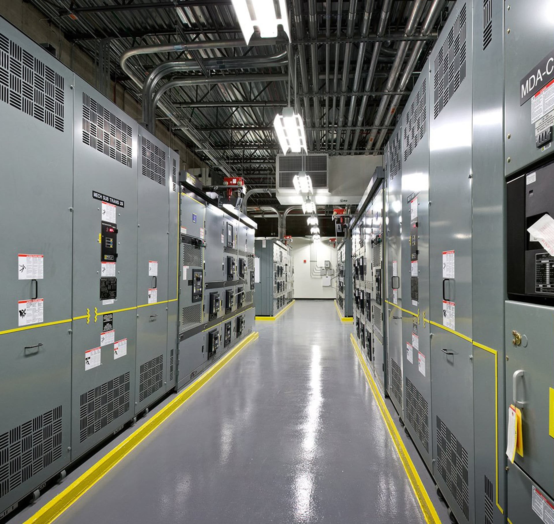 Modern data center interior with electrical equipment.