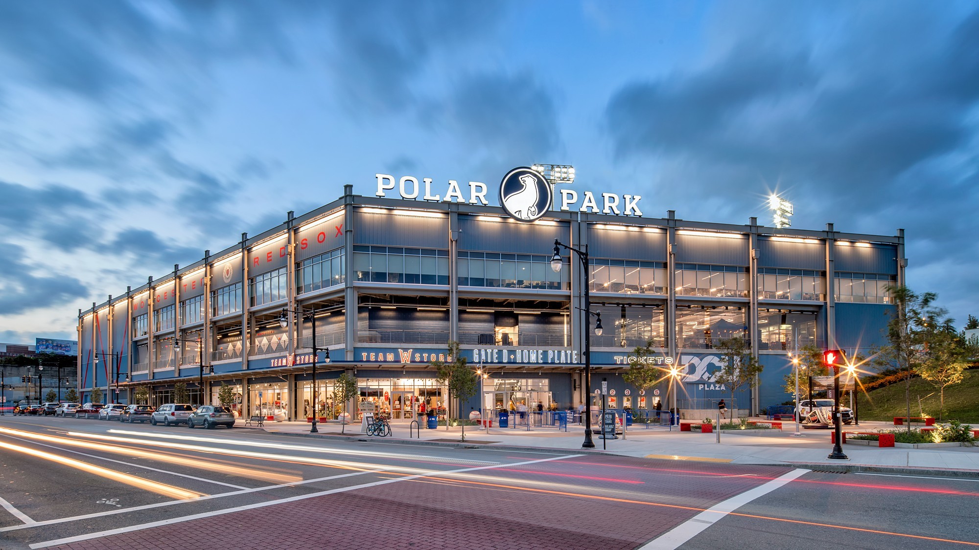 Exterior view of Polar Park baseball stadium at dusk with illuminated signage.