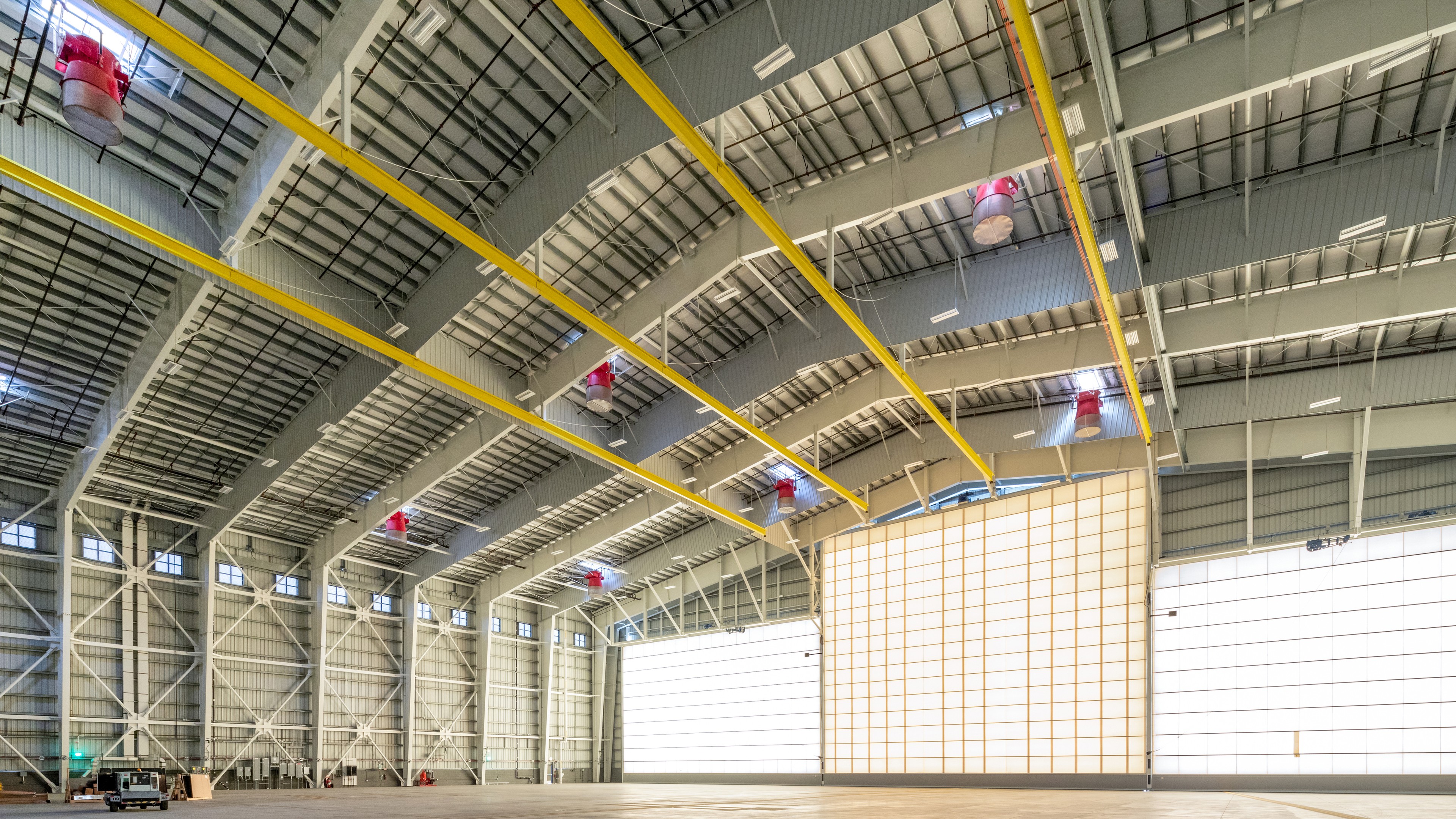 Spacious Modern Industrial Warehouse Interior with High Ceilings Spacious empty industrial warehouse interior with high ceilings and large doors.