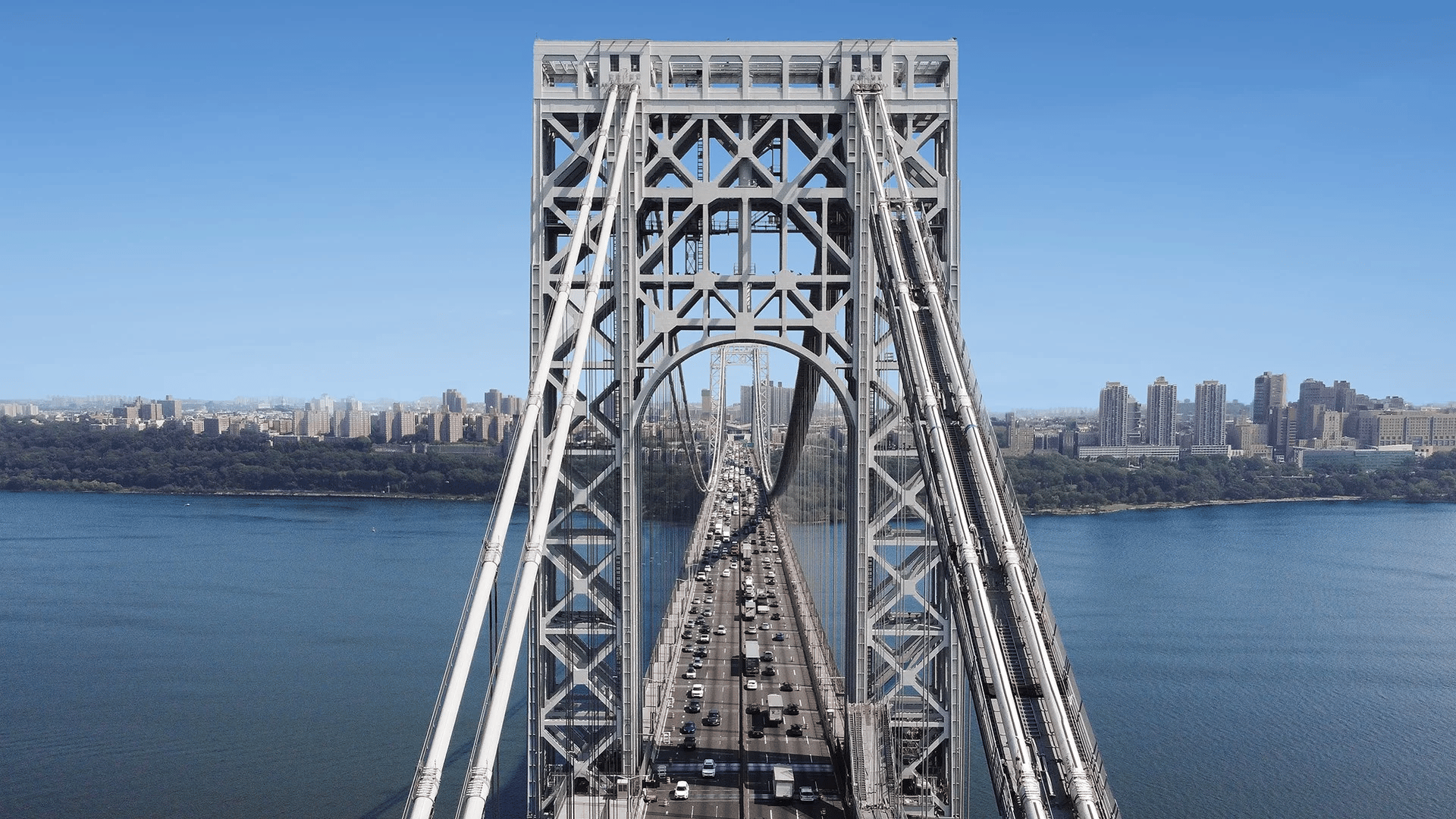 Aerial view of the George Washington Bridge with heavy traffic over the Hudson River.