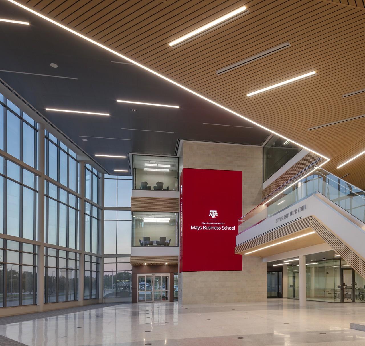 Interior view of Texas A&M Mays Business School with modern design and large windows.