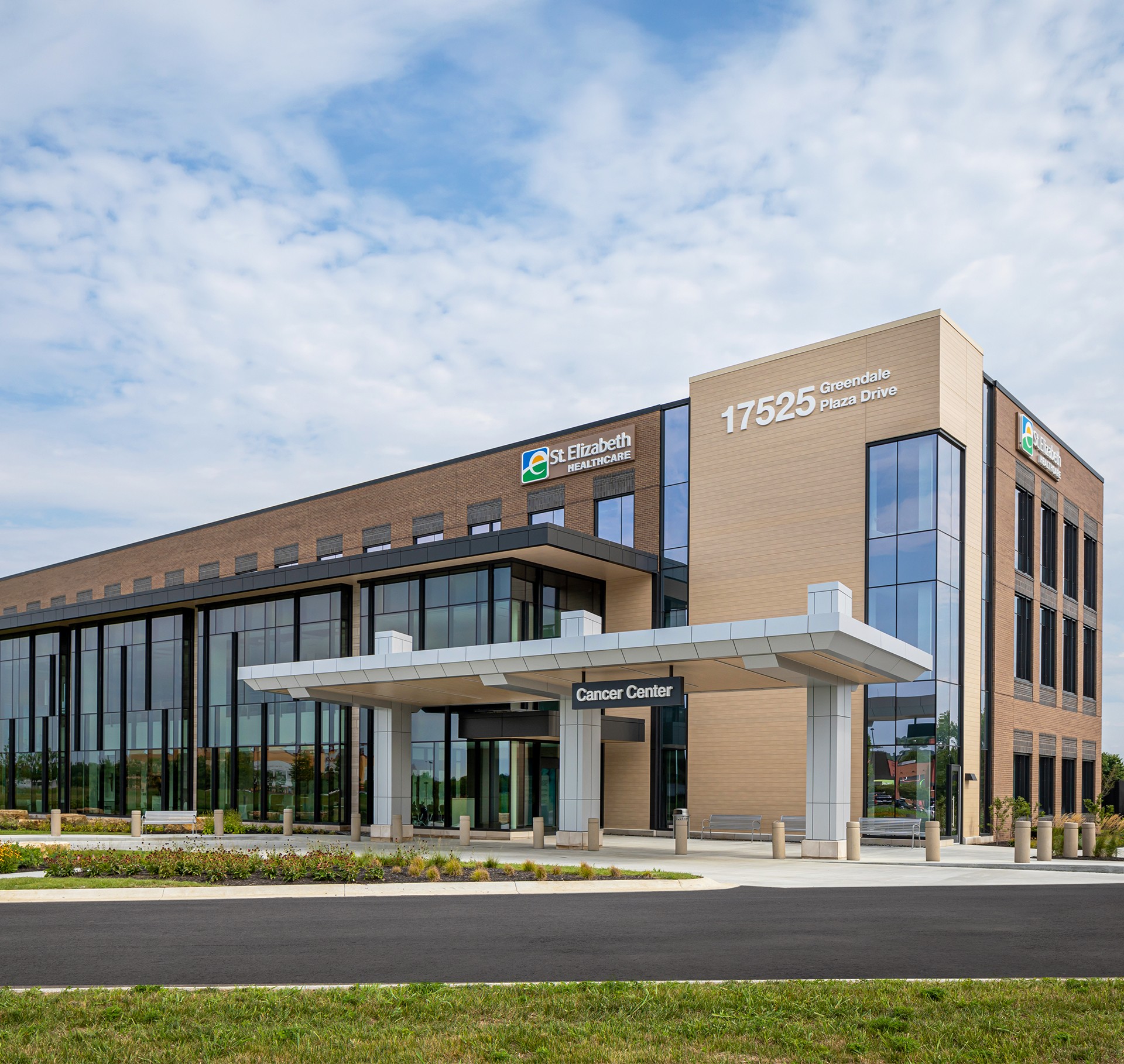 Modern Cancer Center at St. Elizabeth Healthcare, Greendale Modern St. Elizabeth Healthcare building with large windows under a blue sky.