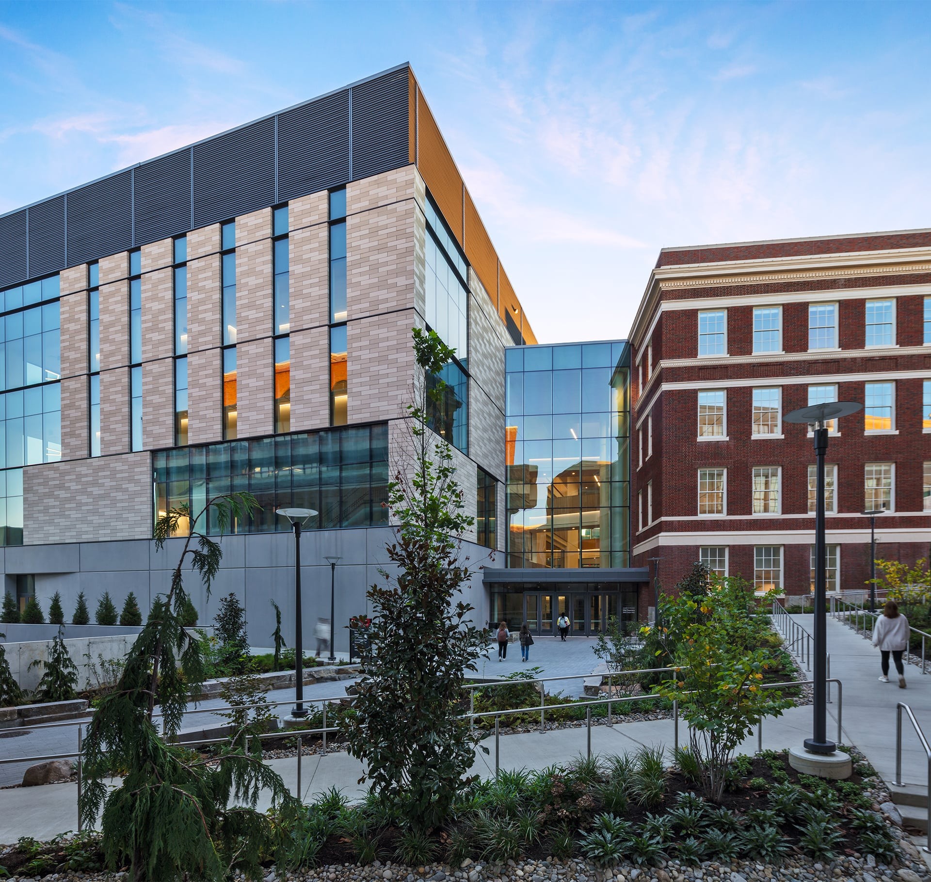 Exterior shot of a higher education academic building with trees and pathways