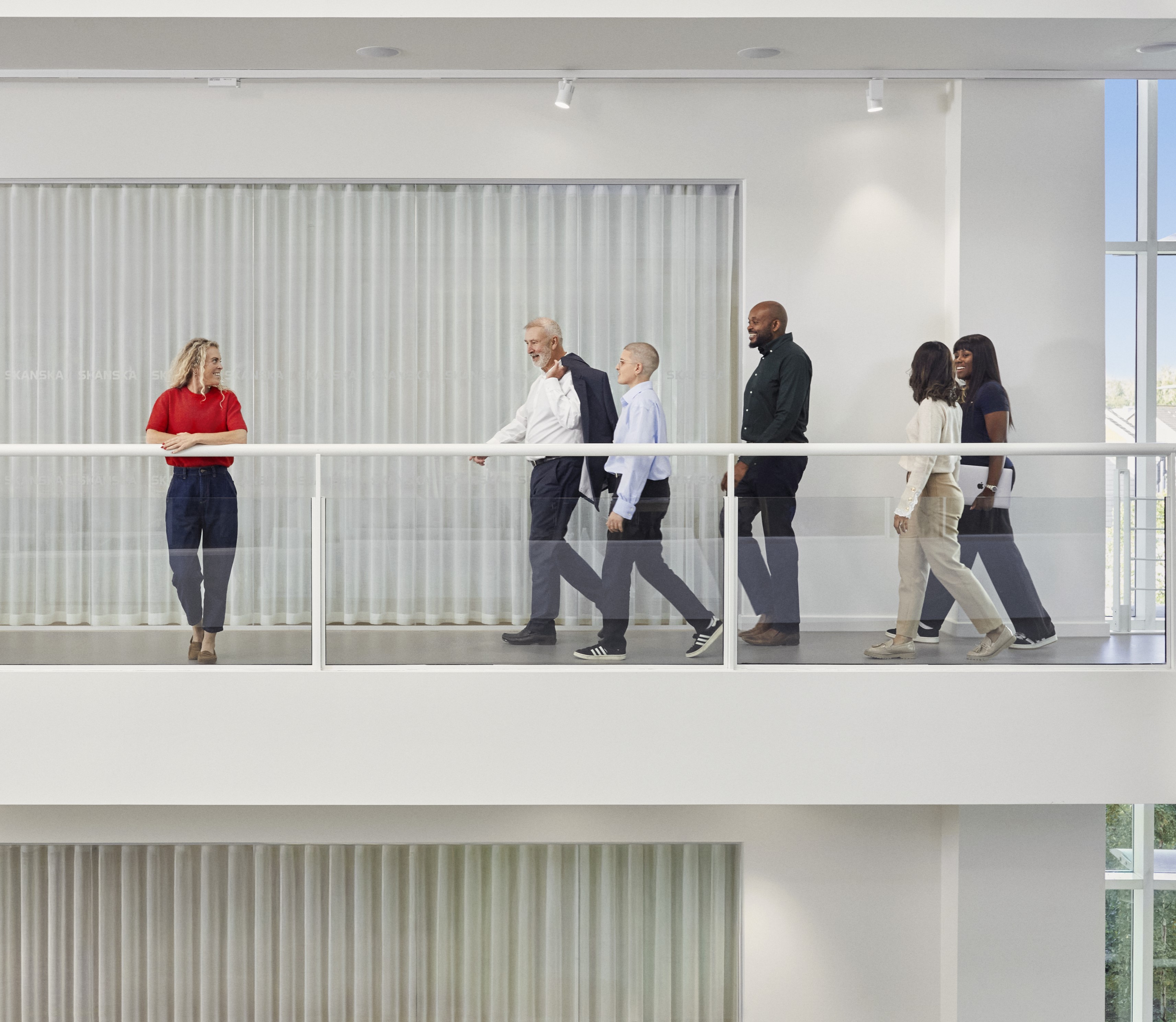 People moving forward in a bright and inspiring office environment.