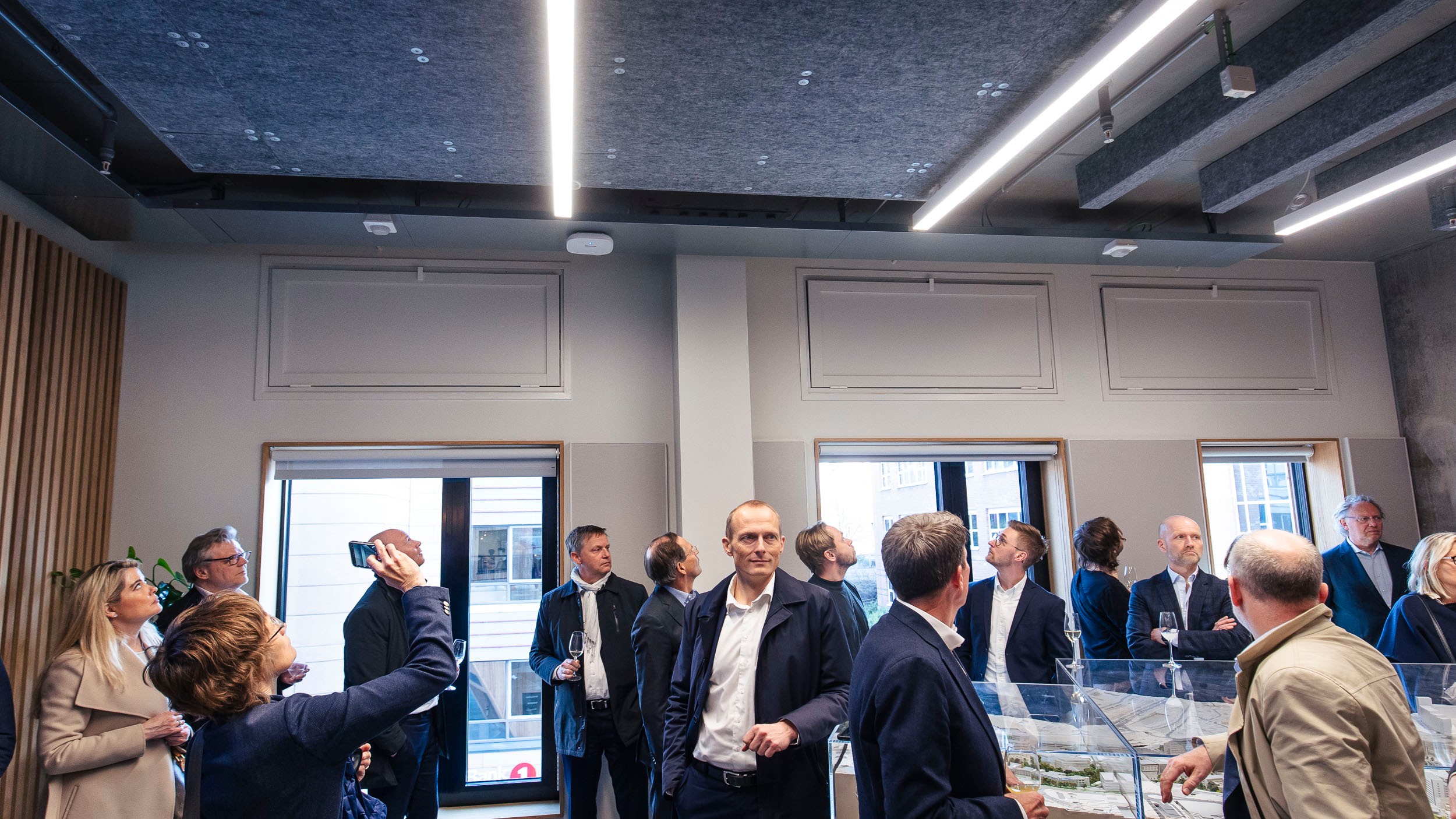 A group of professionals engaged in a discussion inside a modern office space.