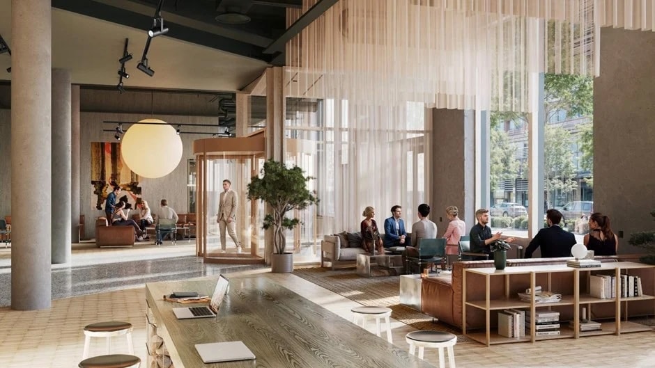Modernt coworking-utrymme med människor som samarbetar, naturligt ljus och stilfull möblering.