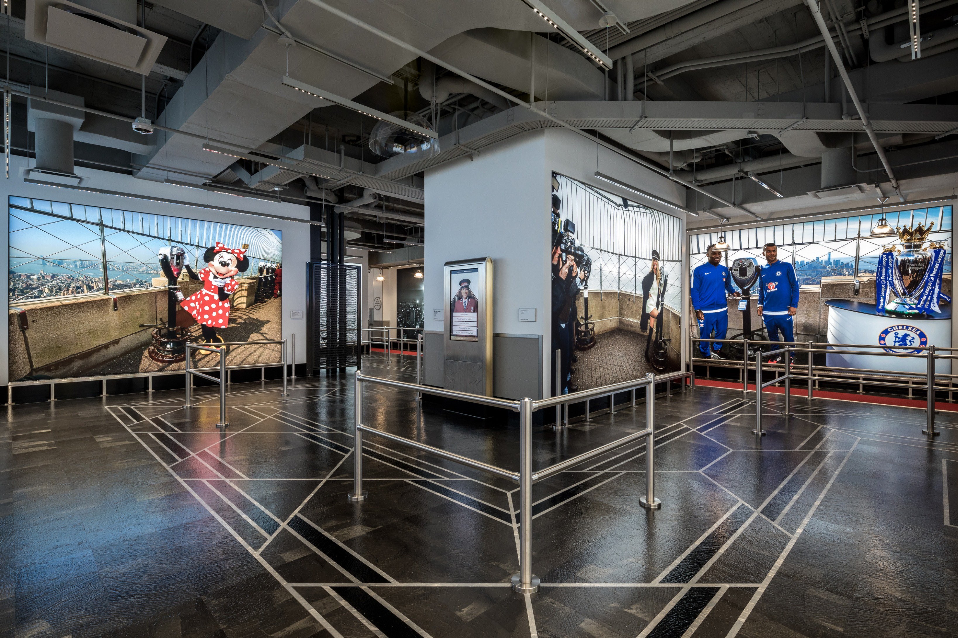 Modern gallery interior showcasing large vibrant photos of iconic characters and athletes.