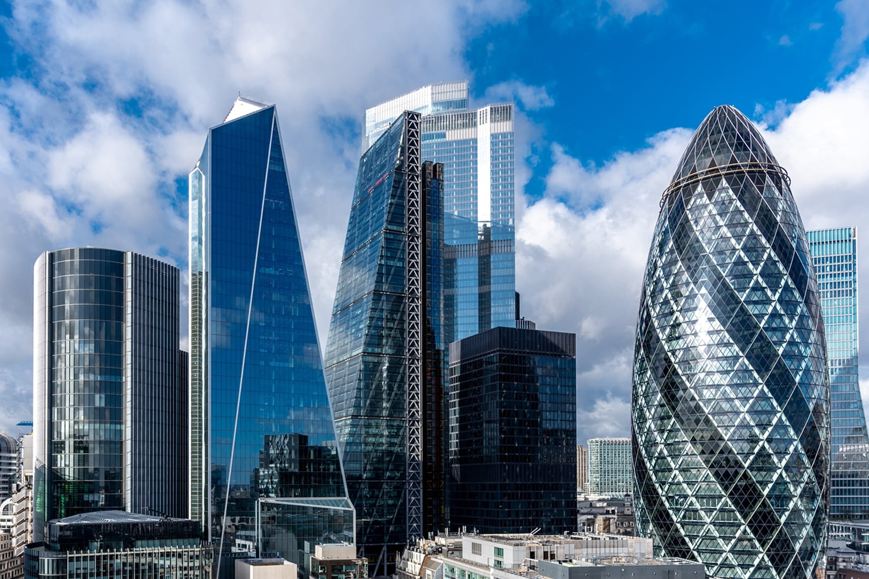 London skyline featuring modern skyscrapers, including the iconic Gherkin building.