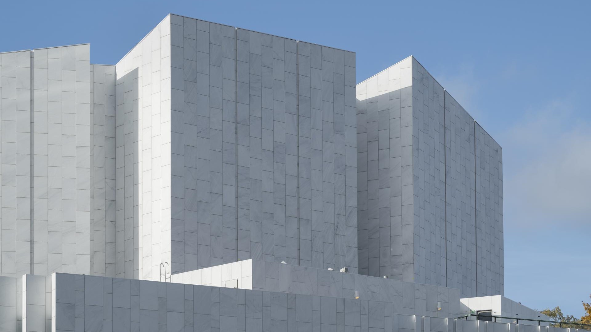 Modern Architectural Building Against Clear Blue Sky Modern white building with geometric architecture set against a clear blue sky.