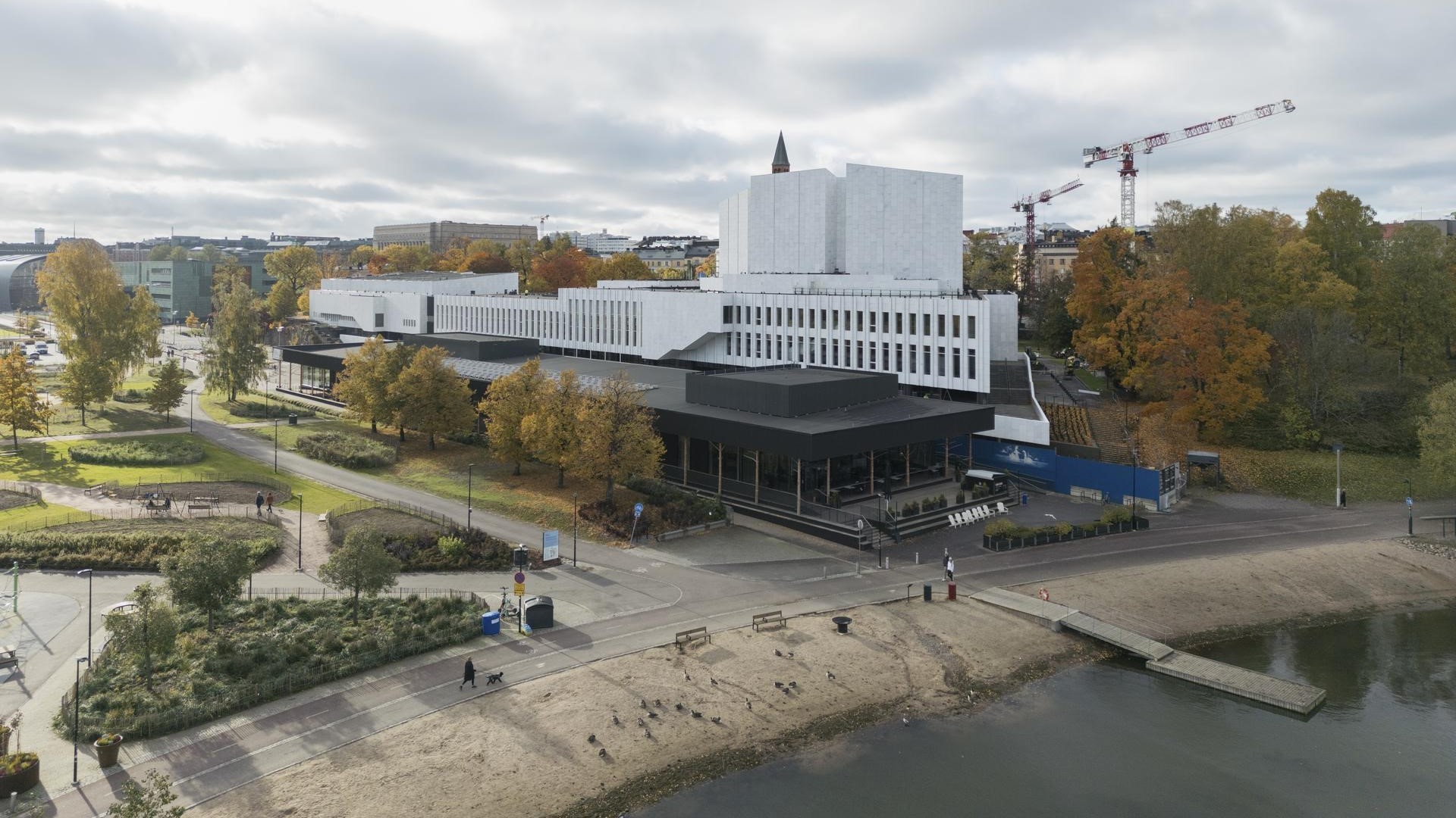 Helsinki's Iconic Finlandia Hall by the Waterfront Aerial view of Finlandia Hall’s white marble building surrounded by trees and nearby structures