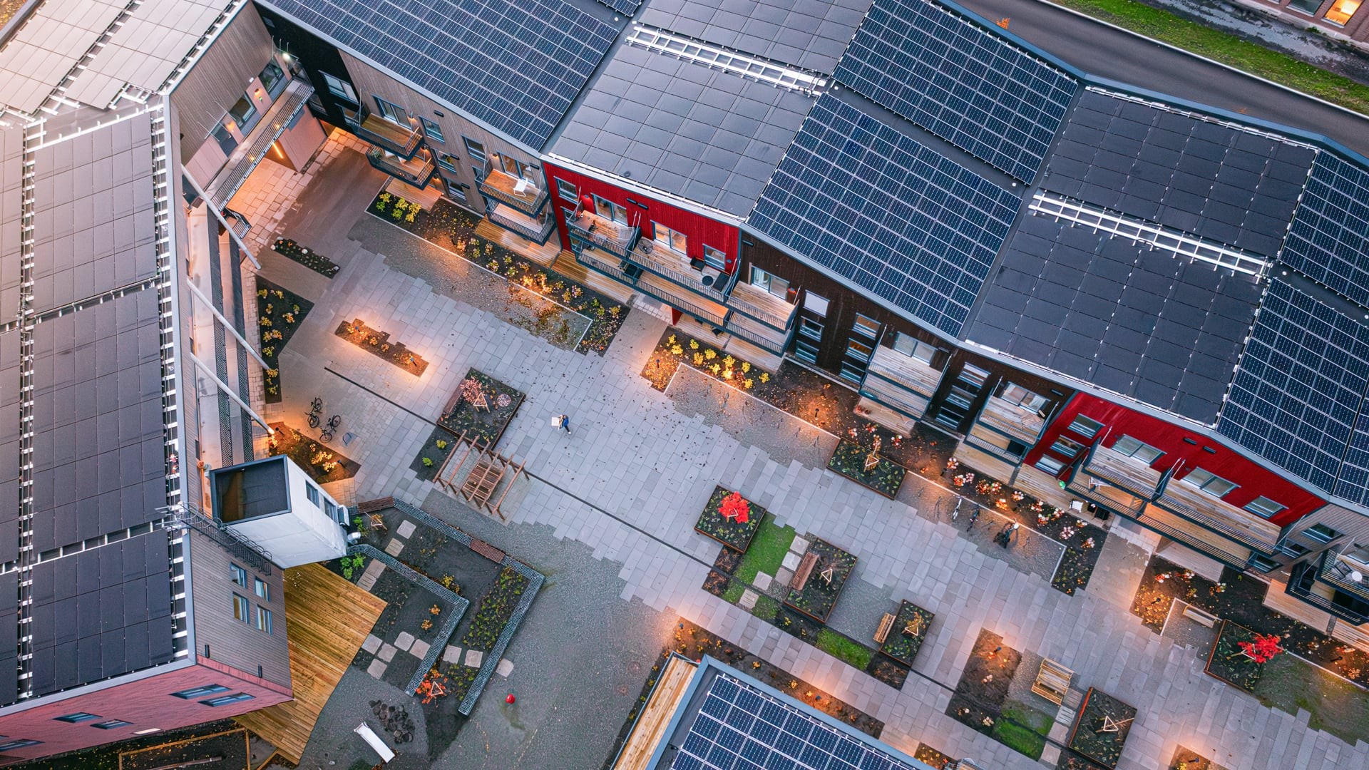 Powerhouse Lade Gartnersletta, Norway Aerial view of modern eco-friendly buildings with solar panels and landscaped courtyard.